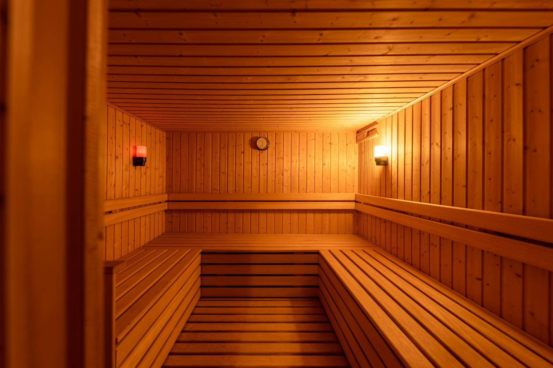 Geräumige Holzsauna mit mehreren Bänken für Entspannung.