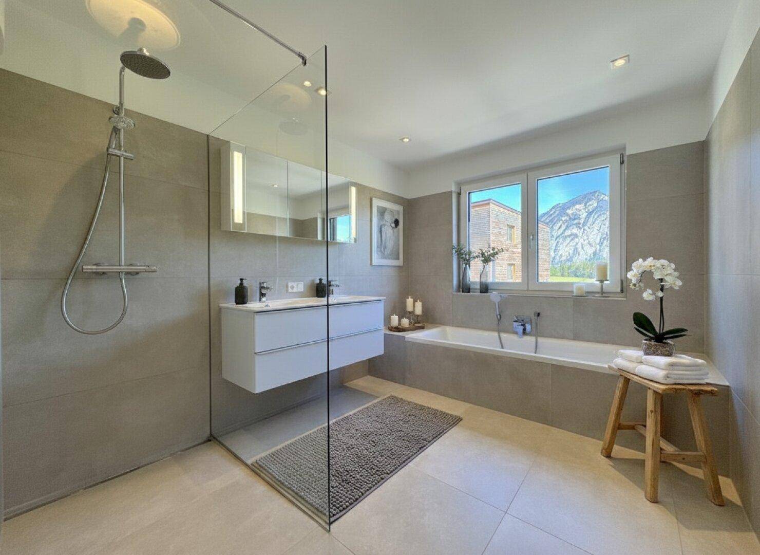 Modernes Badezimmer mit begehbarer Dusche, Badewanne und einem Fenster mit Bergblick.