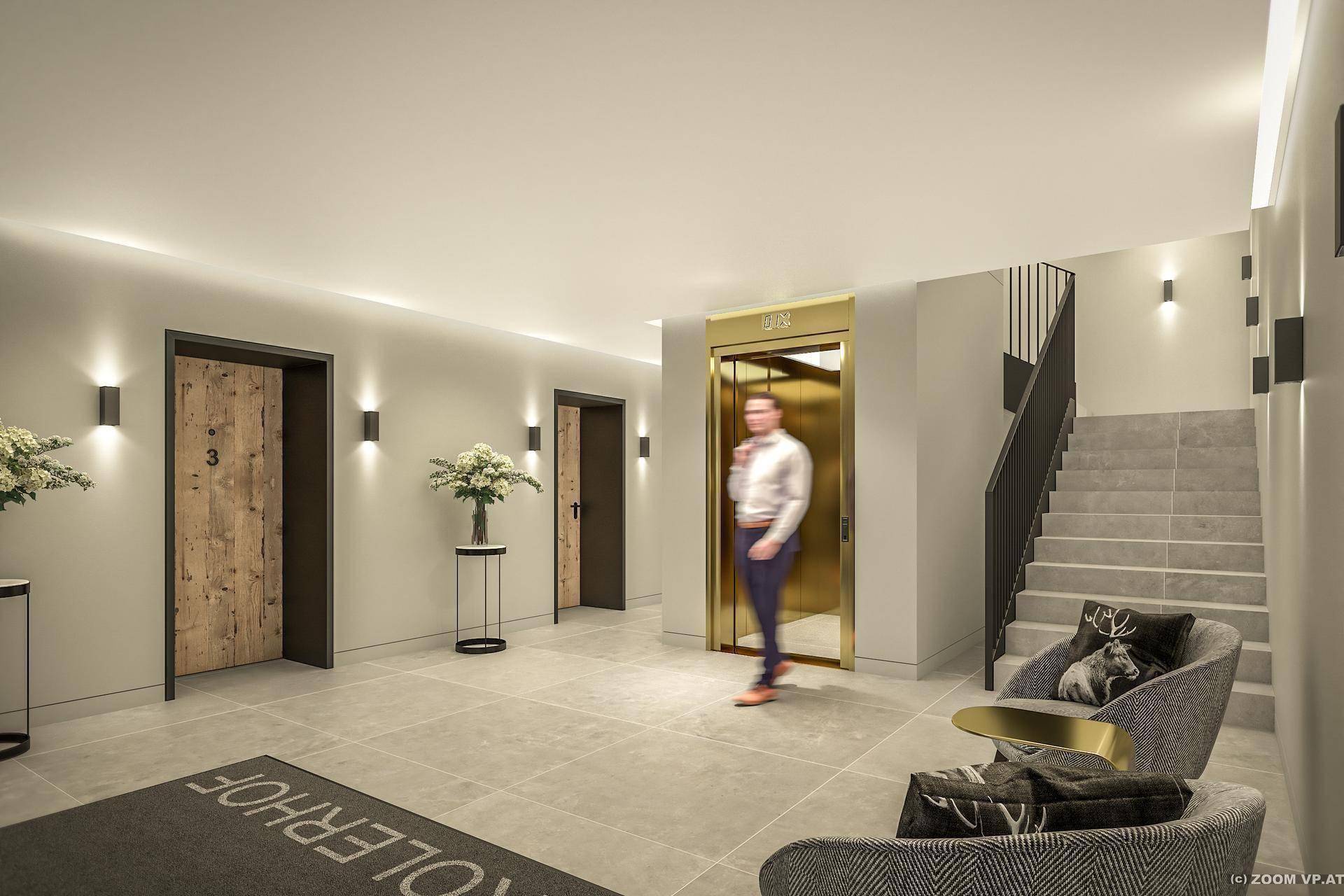Moderner Eingangsbereich mit goldenem Aufzug, Treppe und rustikalen Holztüren zu den Apartments.