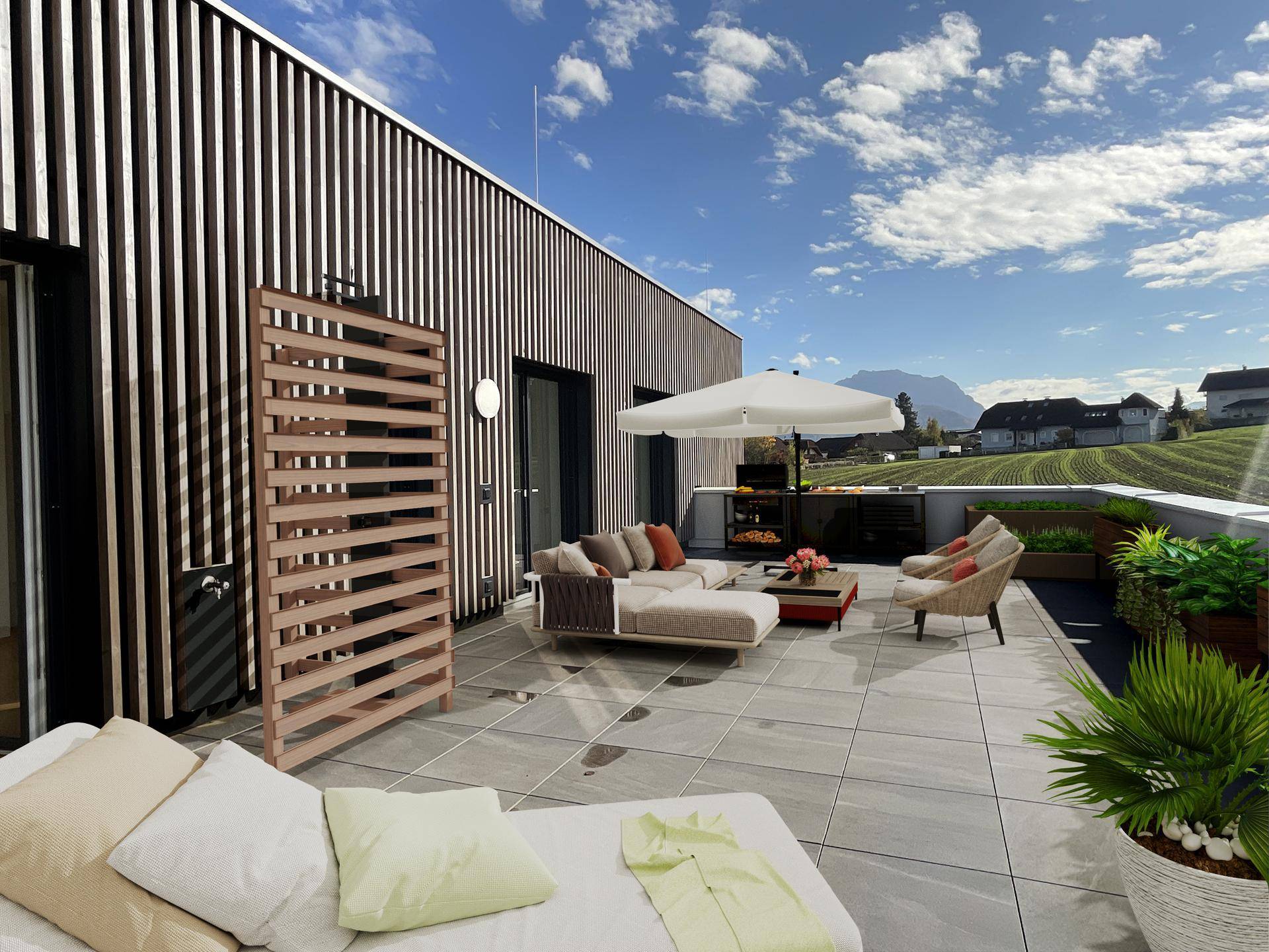 Große, möblierte Dachterrasse mit Grillbereich, Sonnenschirm und weitem Blick in die Landschaft.