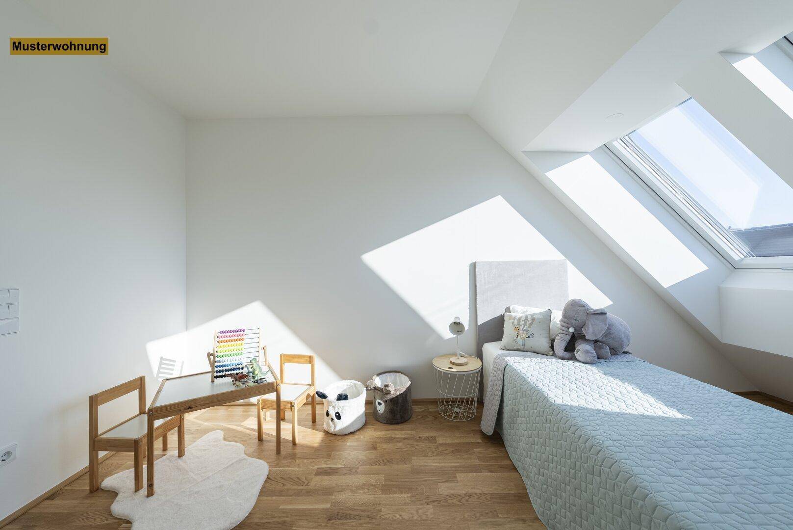 Lichtdurchflutetes Kinderzimmer mit Holzboden, Dachschrägen und einem Spielbereich unter den Dachfenstern.