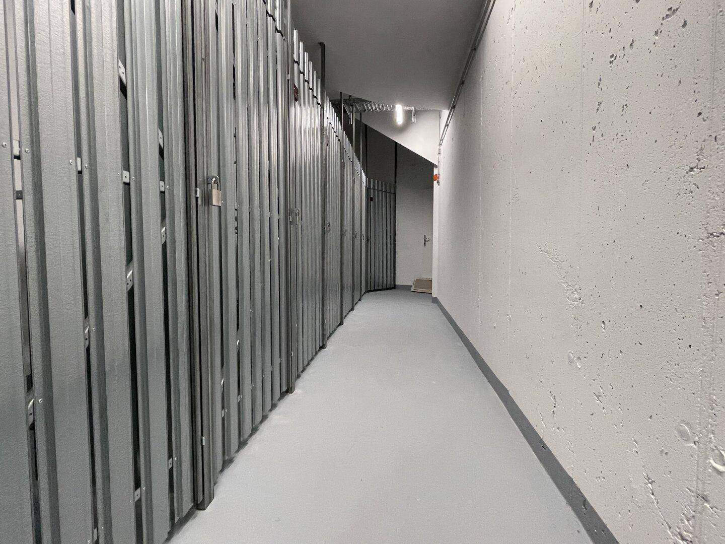 Langer Lagerraum mit vielen Metallabteilen für zusätzlichen Stauraum im Gebäude.