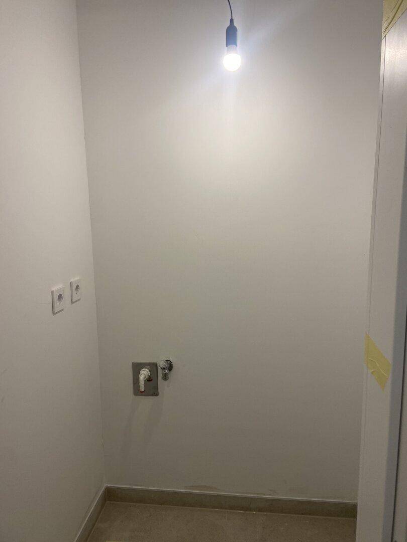 Kleiner Hauswirtschaftsraum mit Anschlüssen für Waschmaschine und Trockner.