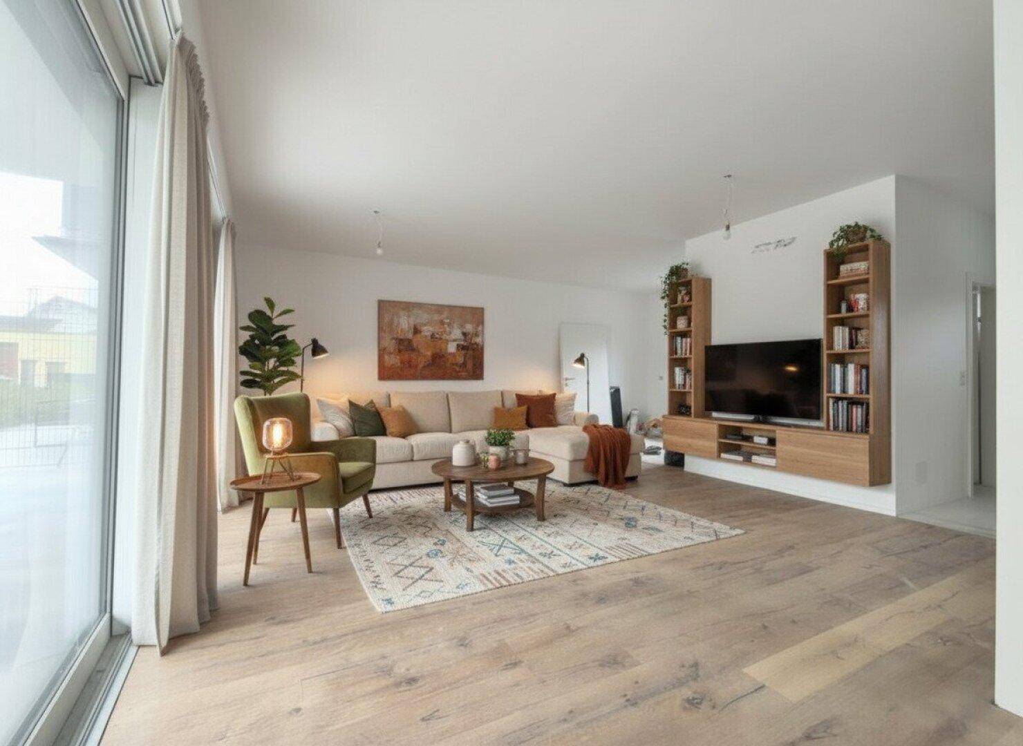 Gemütliches Wohnzimmer mit großem Sofa, modernem TV-Möbel und viel natürlichem Licht durch die Fensterfront.