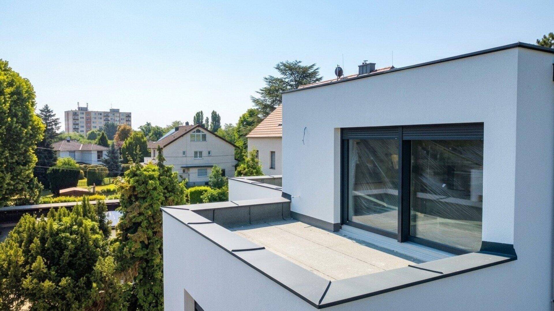 Dachbereich eines modernen Gebäudes mit Blick auf die umliegende Wohnsiedlung.