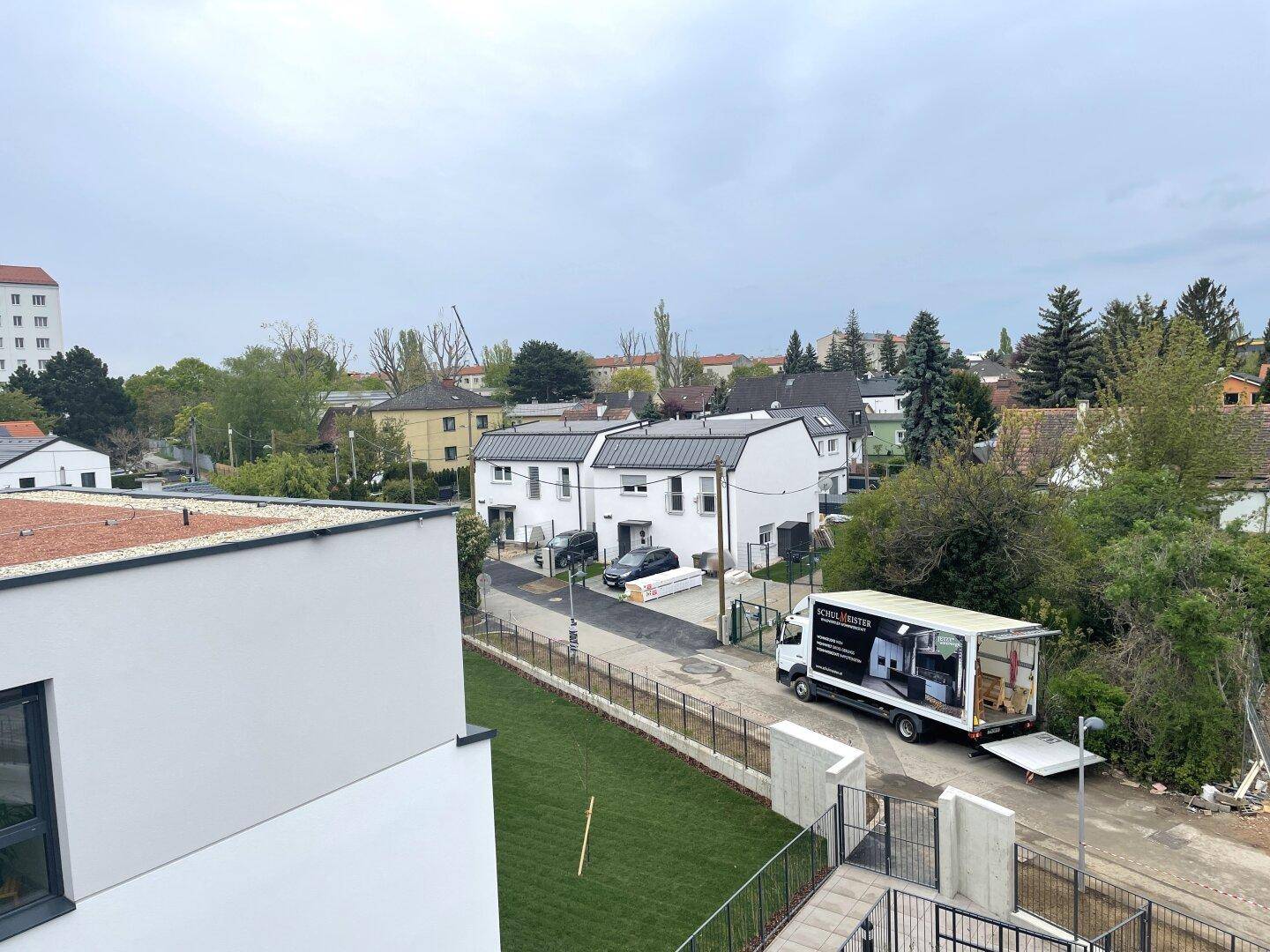 Weitläufiger Blick über die Nachbarschaft mit Wohnhäusern und viel Grün.