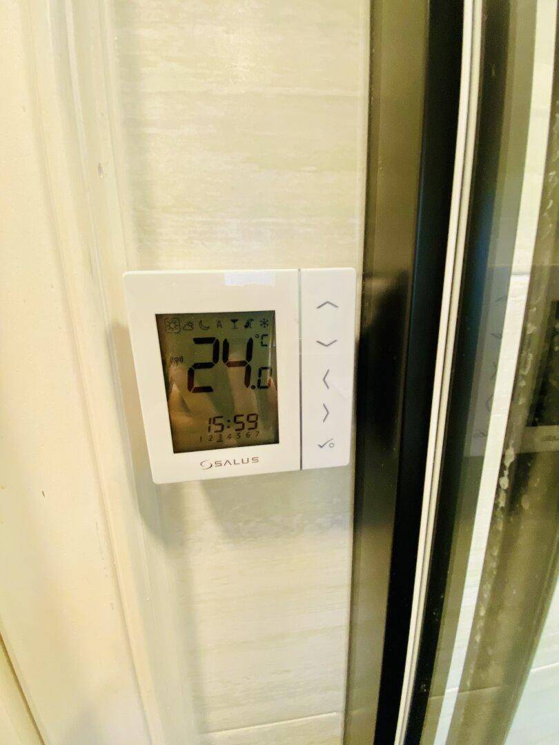 Digitaler Thermostat zur Temperaturregelung in einem Innenraum.