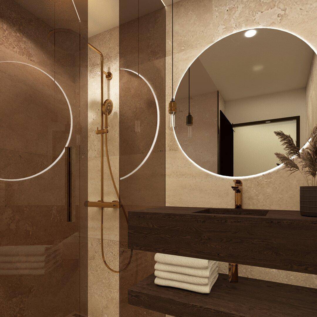 Modernes Badezimmer mit beleuchtetem Spiegel, Holzwaschtisch und goldfarbenen Armaturen in der Dusche.