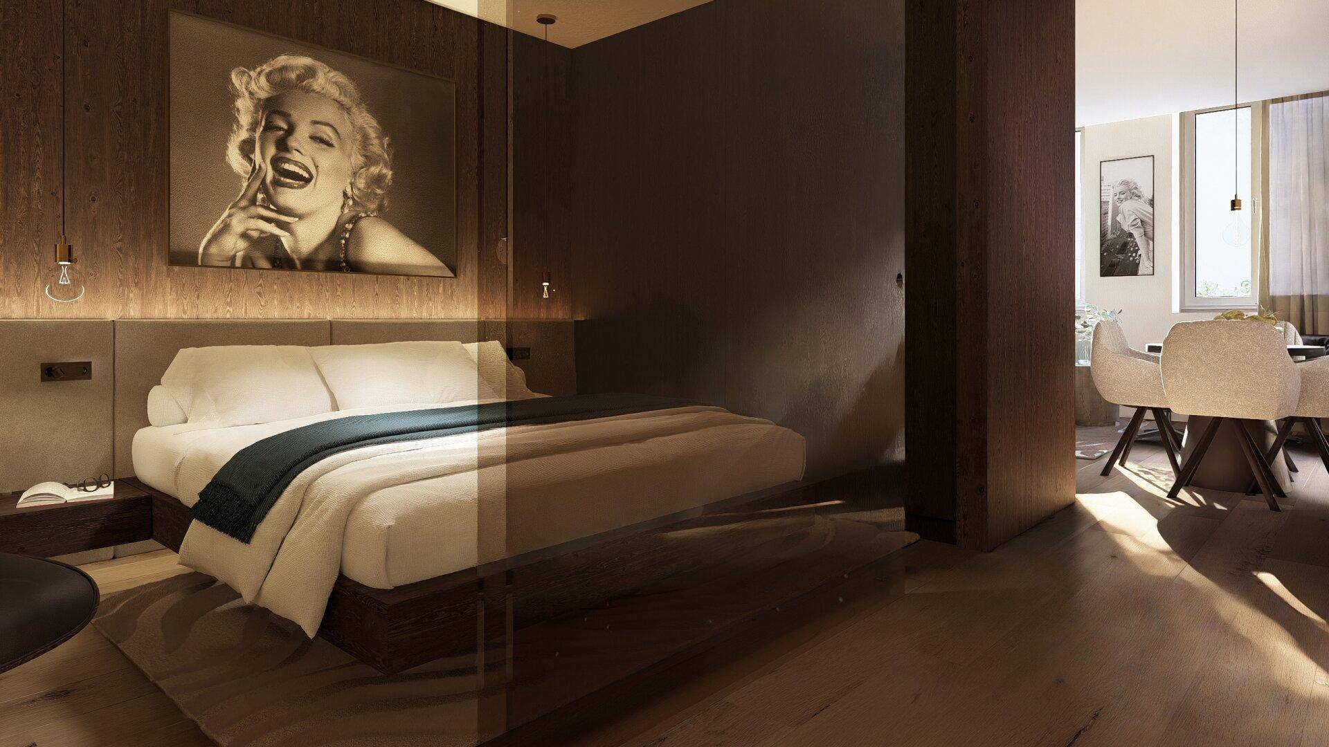 Modernes Schlafzimmer mit großem Bett, Marilyn Monroe Bild und angrenzendem Essbereich.