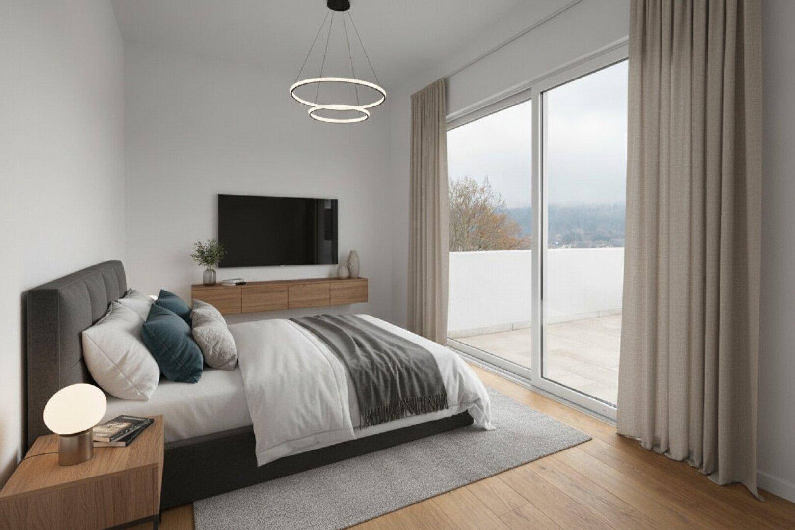 Helles Schlafzimmer mit Zugang zu einer Terrasse, modernen Möbeln und weitem Ausblick.