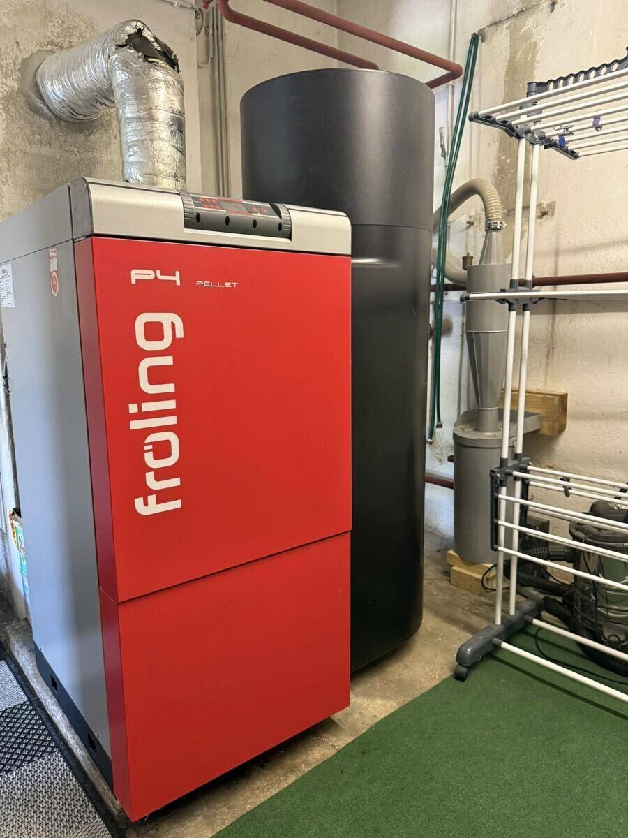 Heizraum mit einer modernen Froling Pelletheizung und Warmwasserspeicher.