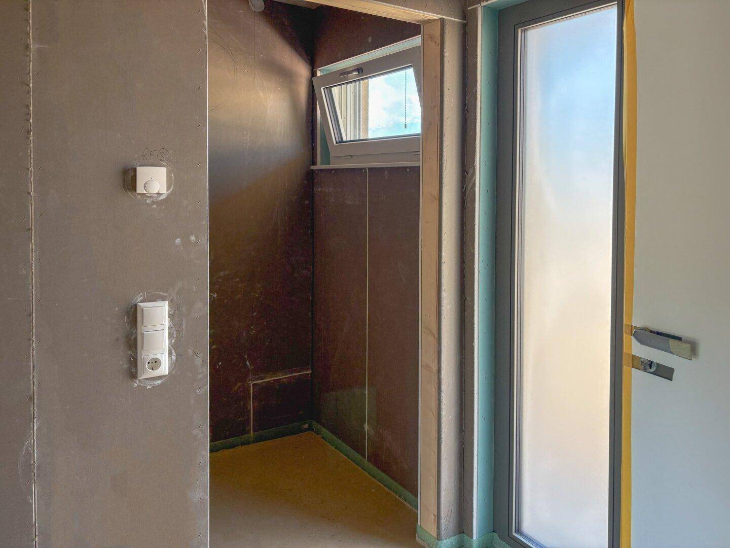 Kleiner Raum im Rohbau mit Fenster, ideal für ein Gäste-WC oder Abstellraum.