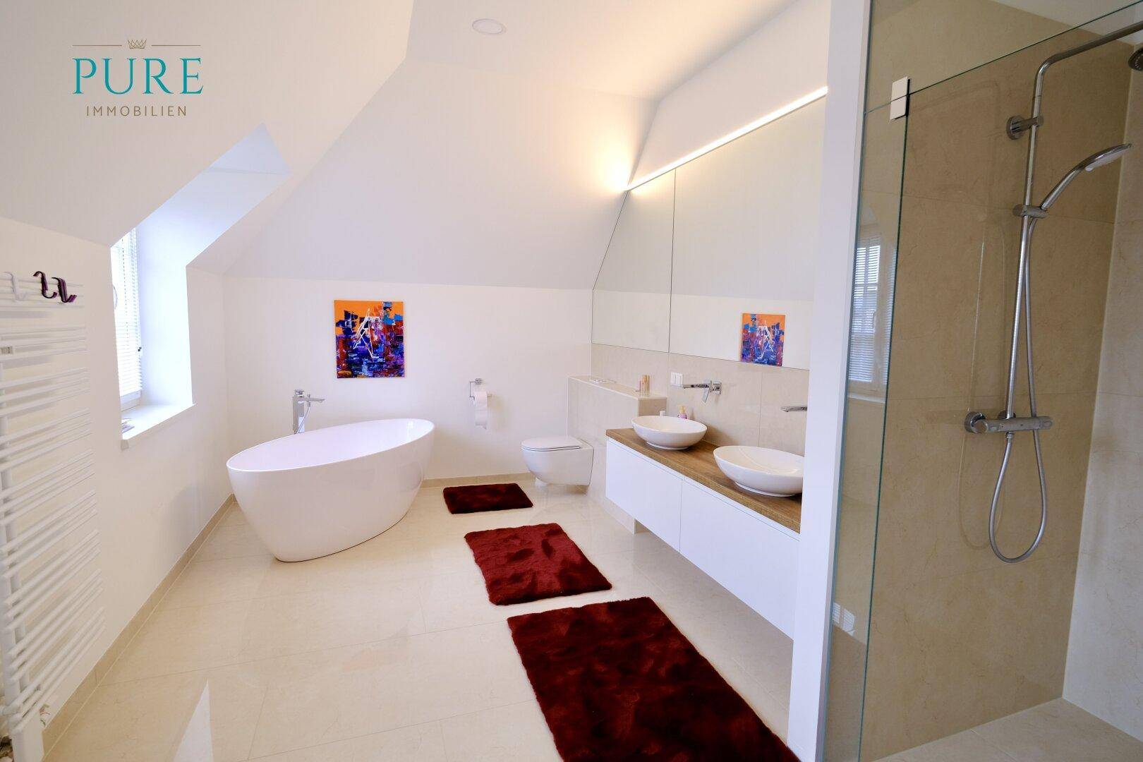 Modernes Badezimmer mit freistehender Badewanne, Doppelwaschbecken und begehbarer Dusche.