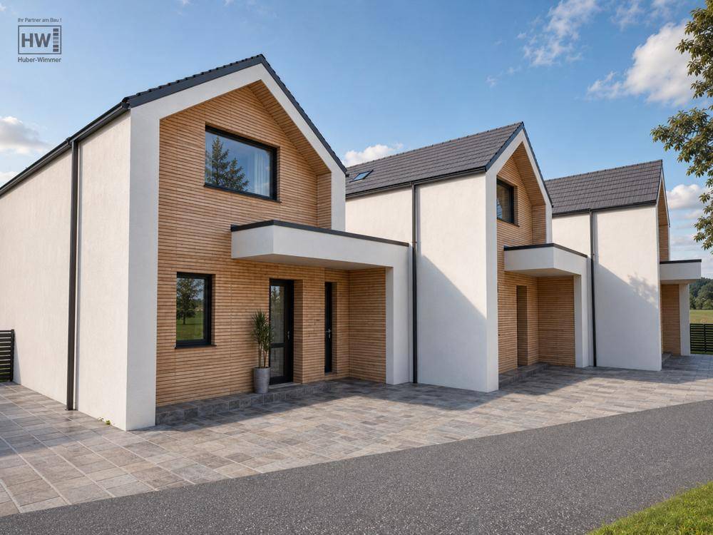 Reihenhäuser mit zeitgenössischem Design, weißer Fassade und dunklem Satteldach in ländlicher Lage.