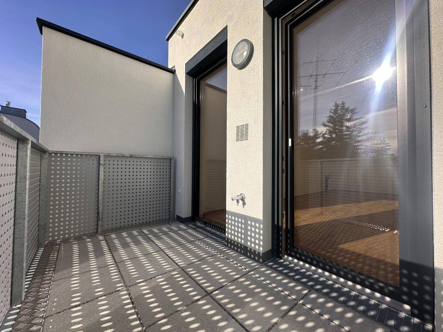 Sonniger Balkon mit Blick auf die Umgebung, ideal für entspannte Stunden im Freien.