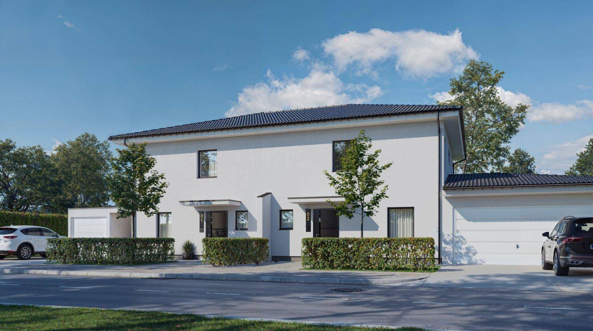 Ansicht der modernen Doppelhaushälfte von der Straße mit Garagen und Carport.