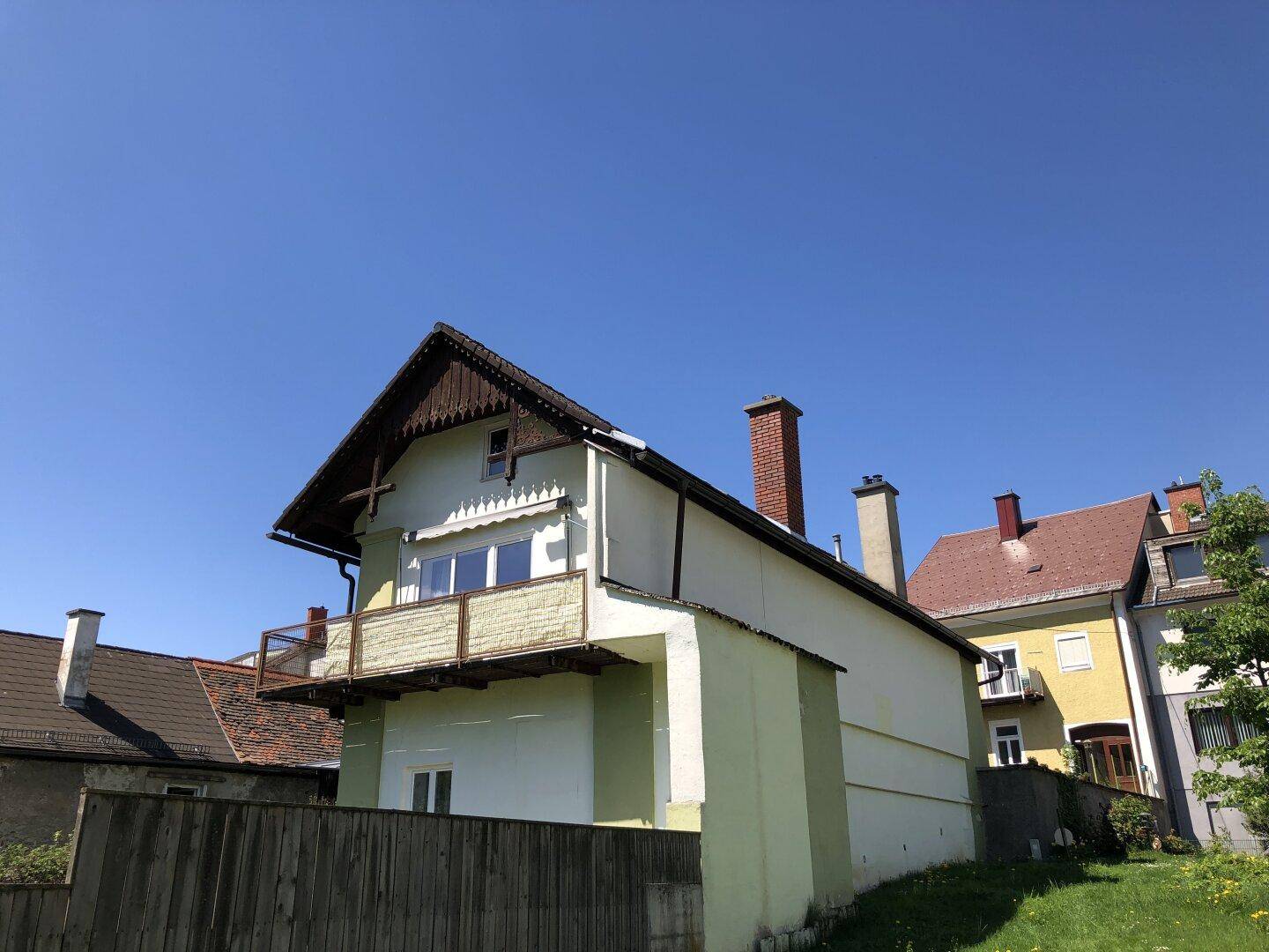 Blick vom nachbarschaftlichen Parkplatz aufs gartenseitige Haus