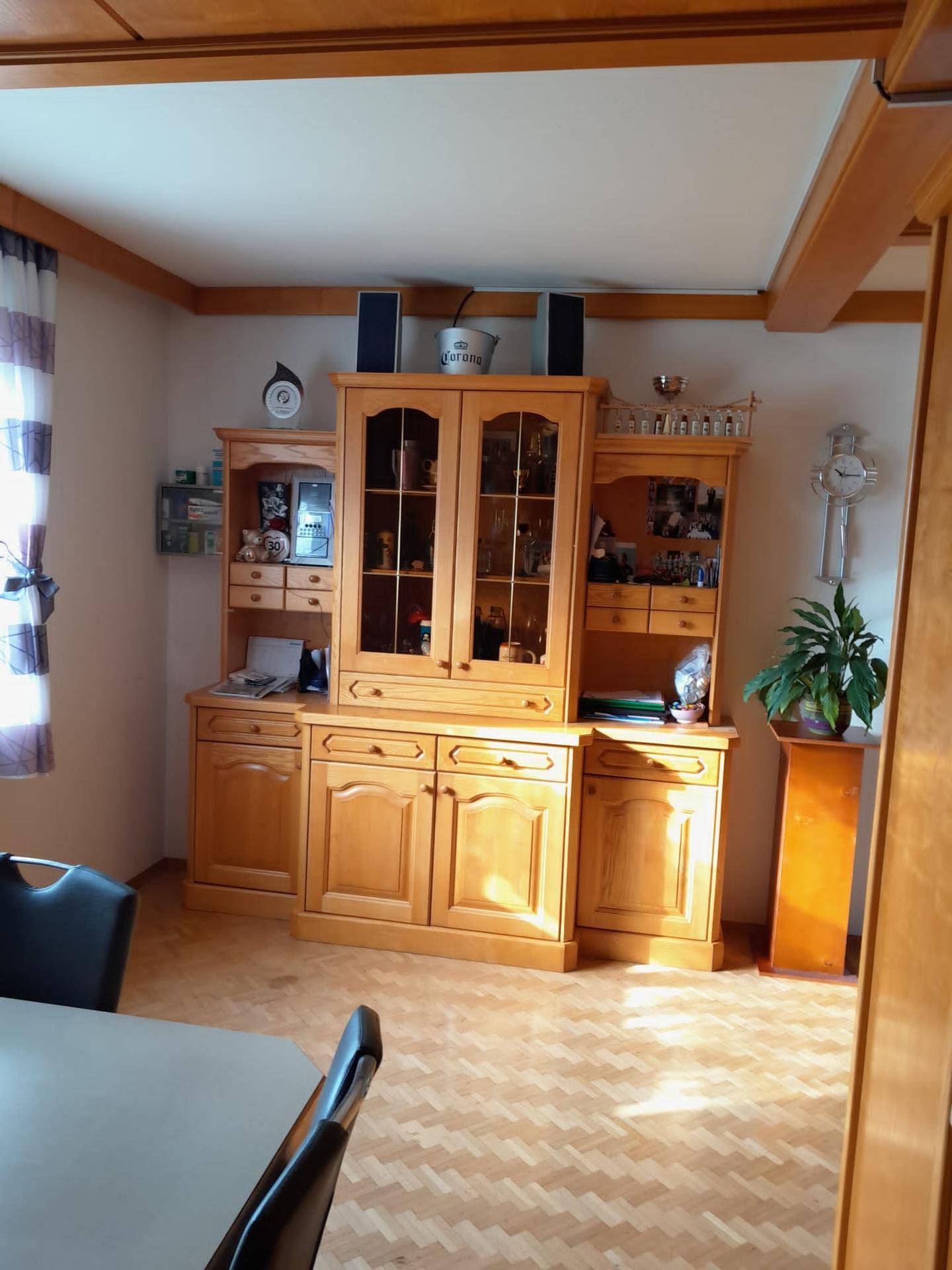 Essbereich mit großem Holzschrank, traditionellen Möbeln und Laminatboden.