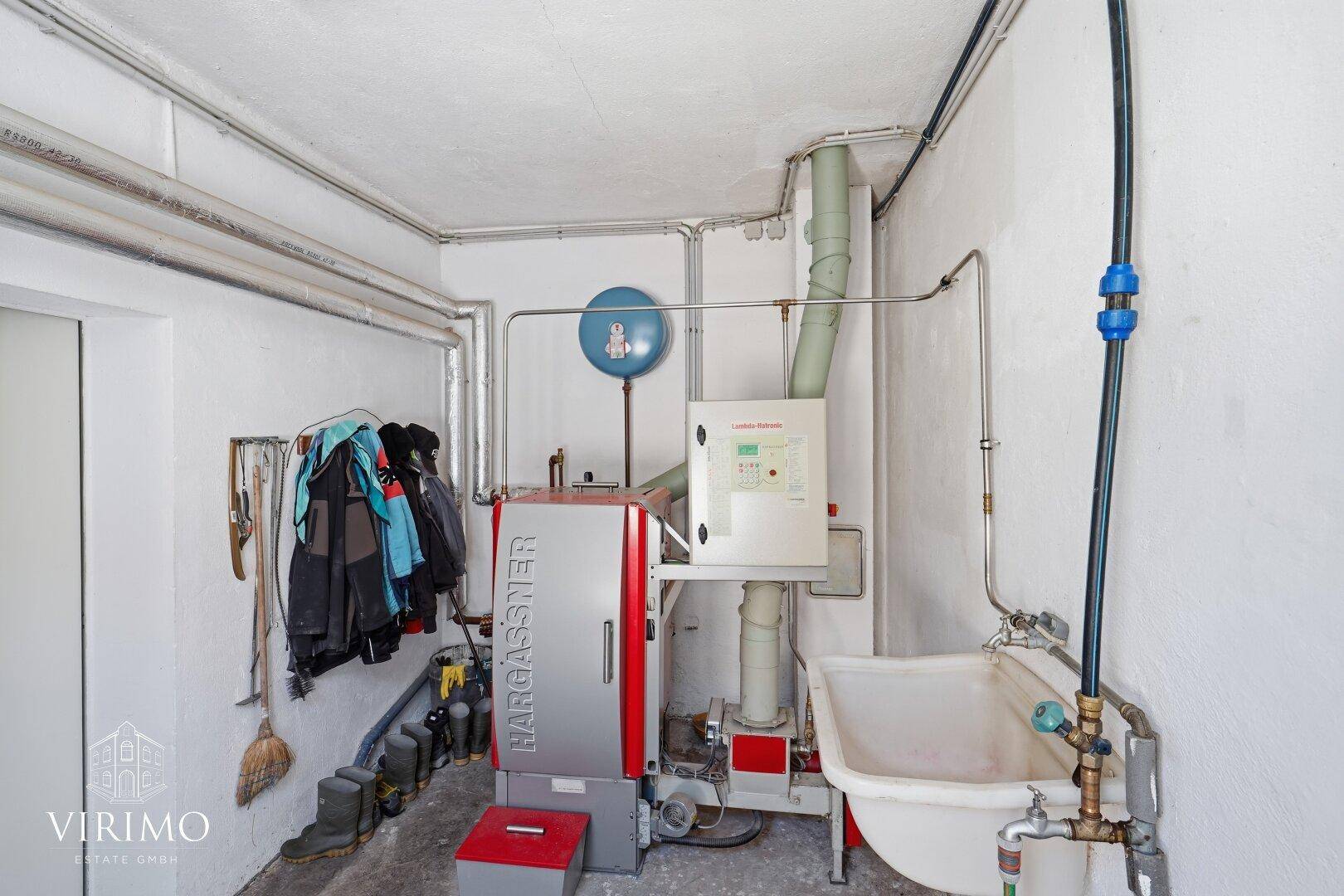 Heizungsraum mit moderner Heizungsanlage und Waschbecken, funktional eingerichtet.
