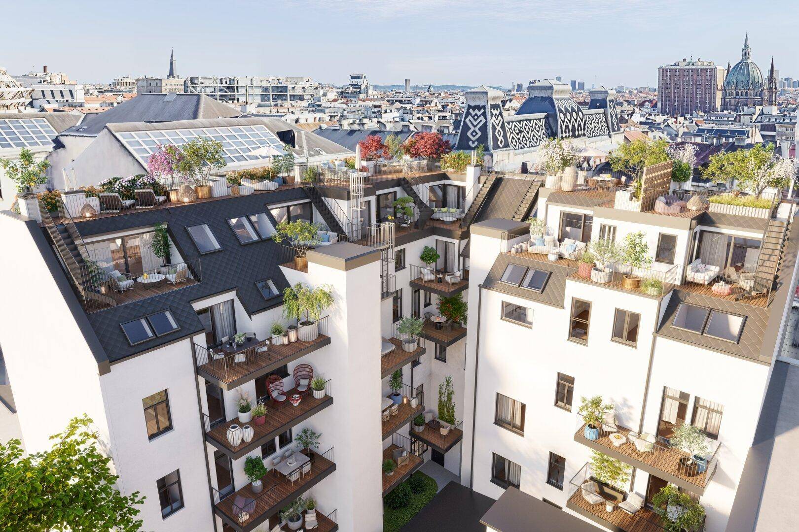 Innenhofansicht mit zahlreichen Balkonen und Dachterrassen in einem modernen Wohnkomplex.
