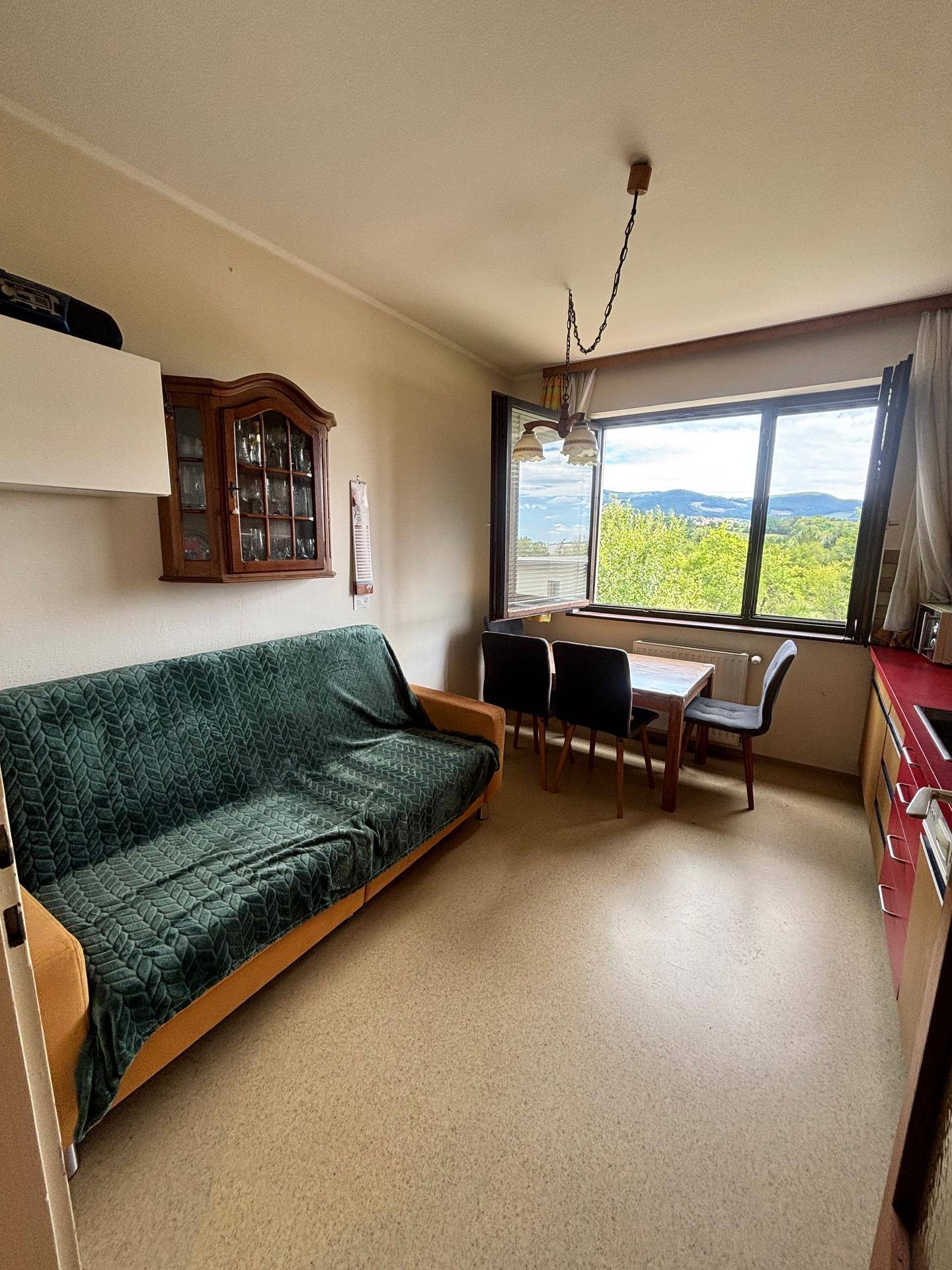 Geräumige Küche mit Essbereich, Sofa und Blick auf die umliegende Landschaft.