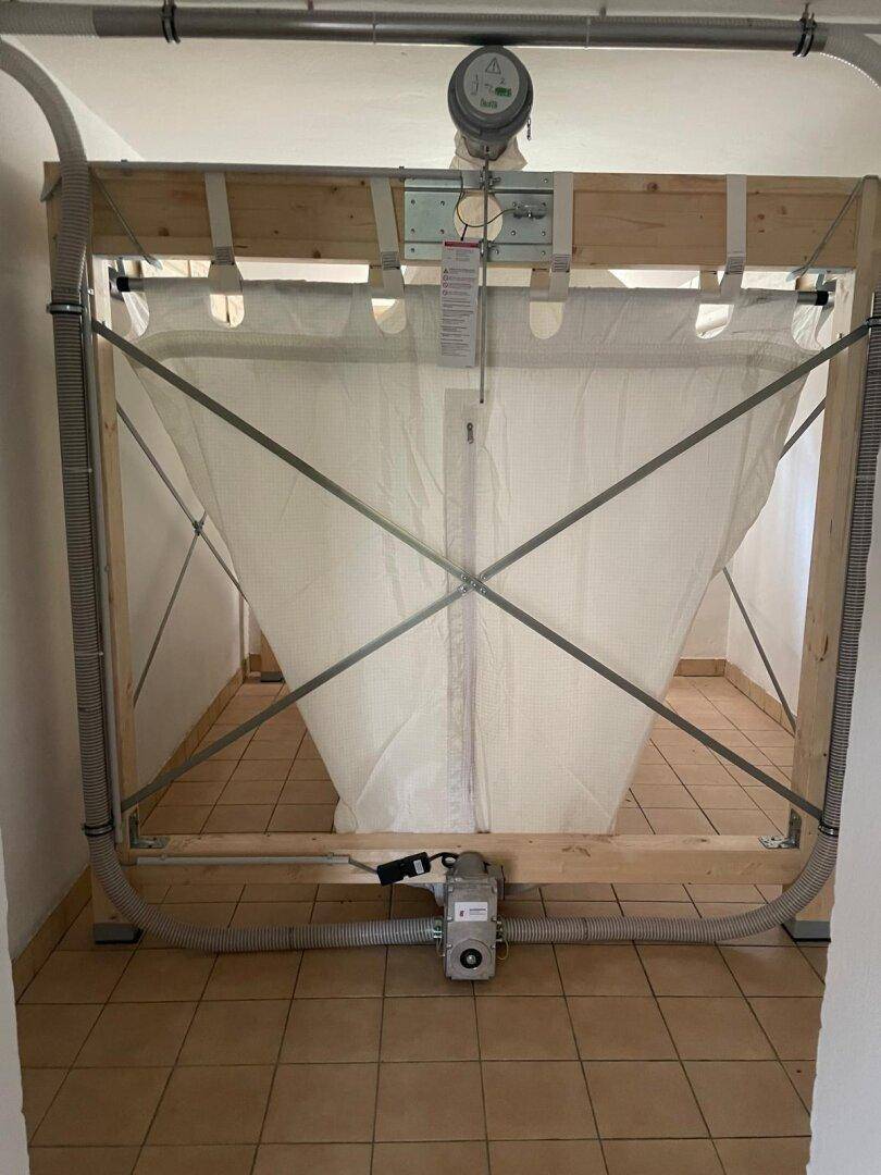 Pelletlager mit flexiblem Silo und Zuführsystem in einem Technikraum für die Heizungsanlage.