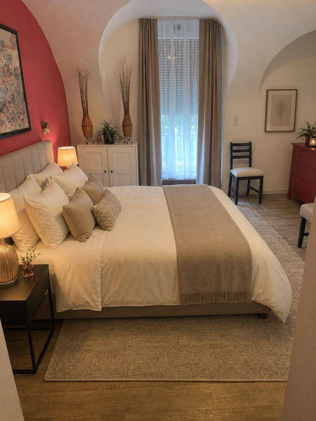 Gemütliches Schlafzimmer mit gewölbter Decke, Holzboden und modernem Bett mit Nachttischen.