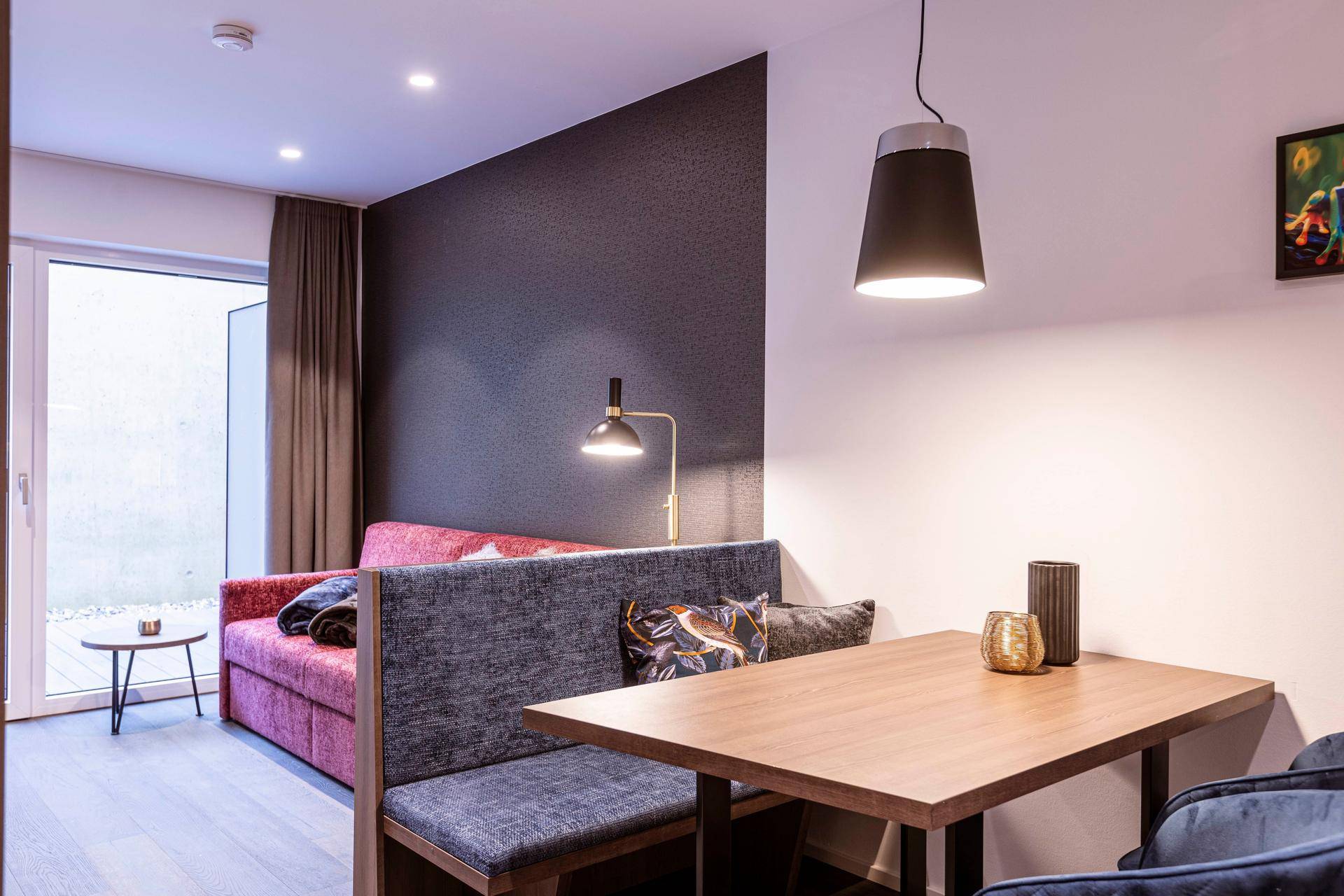 Gemütlicher Wohn- und Essbereich mit Sofa und Esstisch, ideal für entspannte Abende.