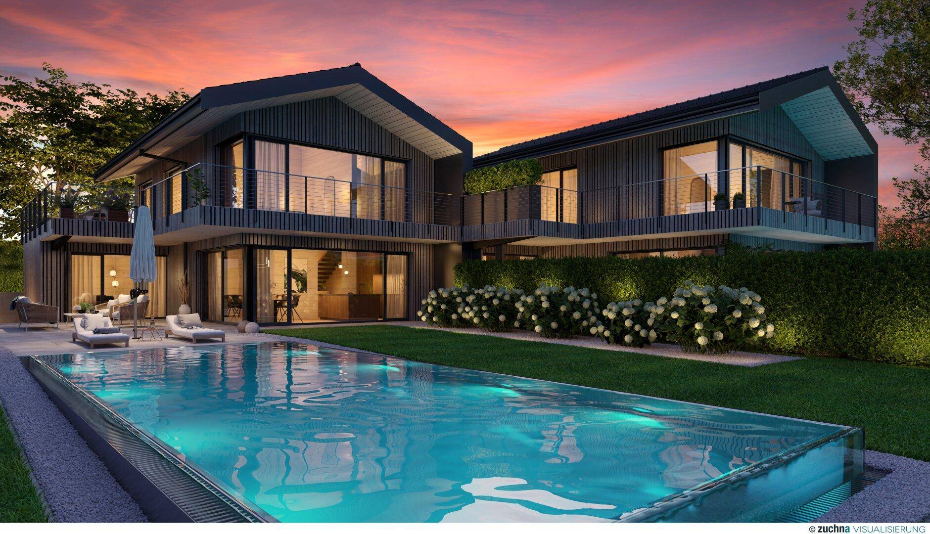 Moderne Doppelhäuser mit beleuchteten Pools und Gärten bei Sonnenuntergang.