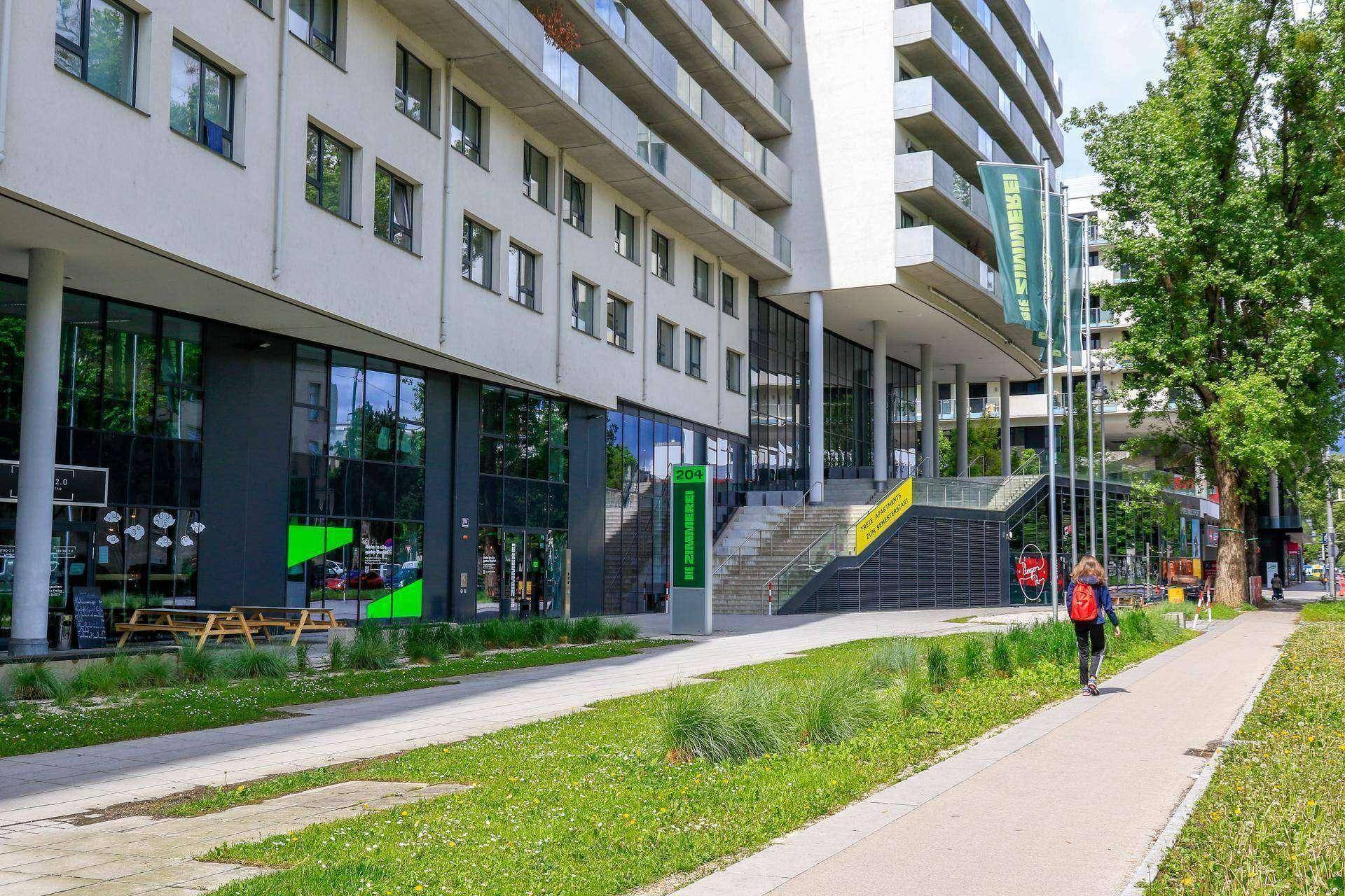 Erdgeschoss eines modernen Gebäudes mit großen Schaufenstern und Zugangsbereich.