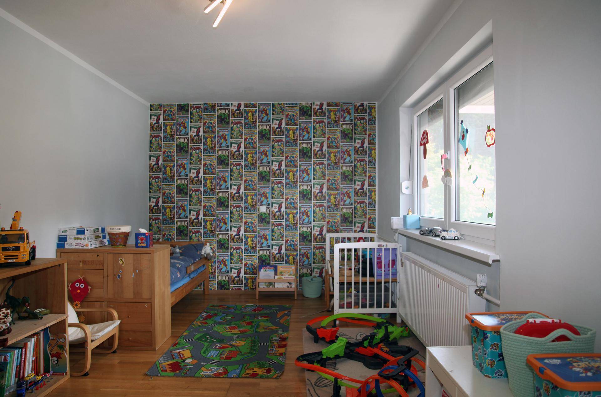 Farbenfrohes Kinderzimmer mit Holzboden, Spielzeug und gemusterter Tapete.