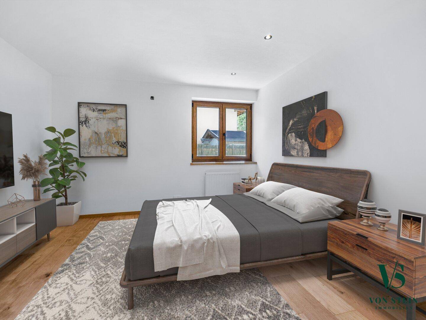 Komfortables Schlafzimmer mit Holzboden, modernem Bett und Blick ins Grüne.