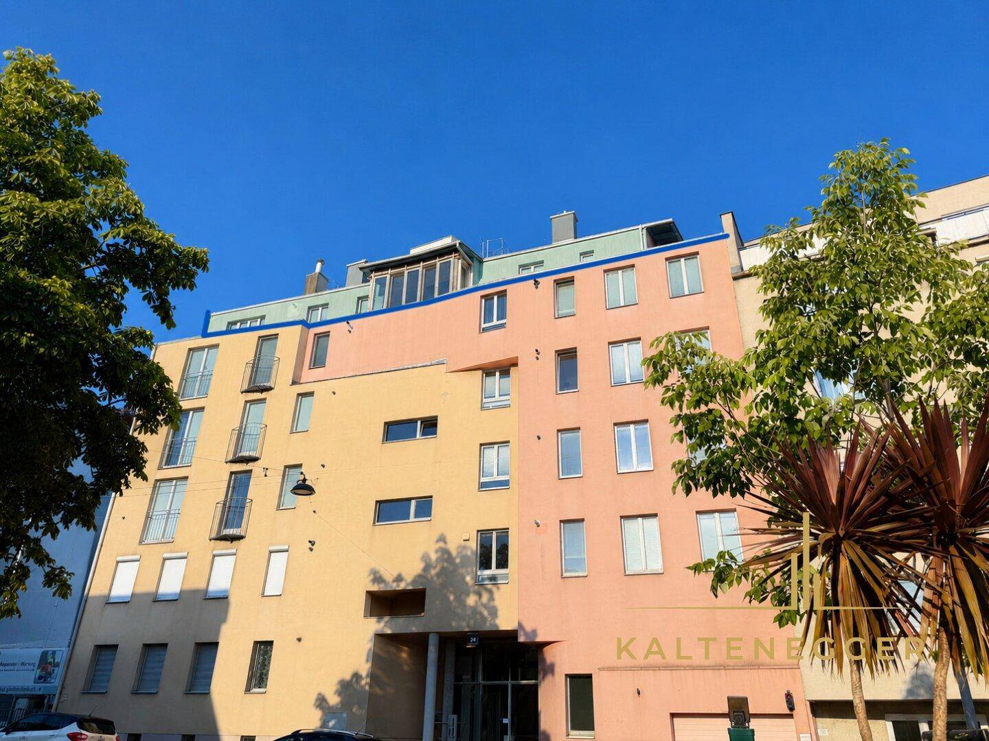 Ansicht der modernen Wohnhausfassade mit verschiedenen Farbtönen und Fenstern.