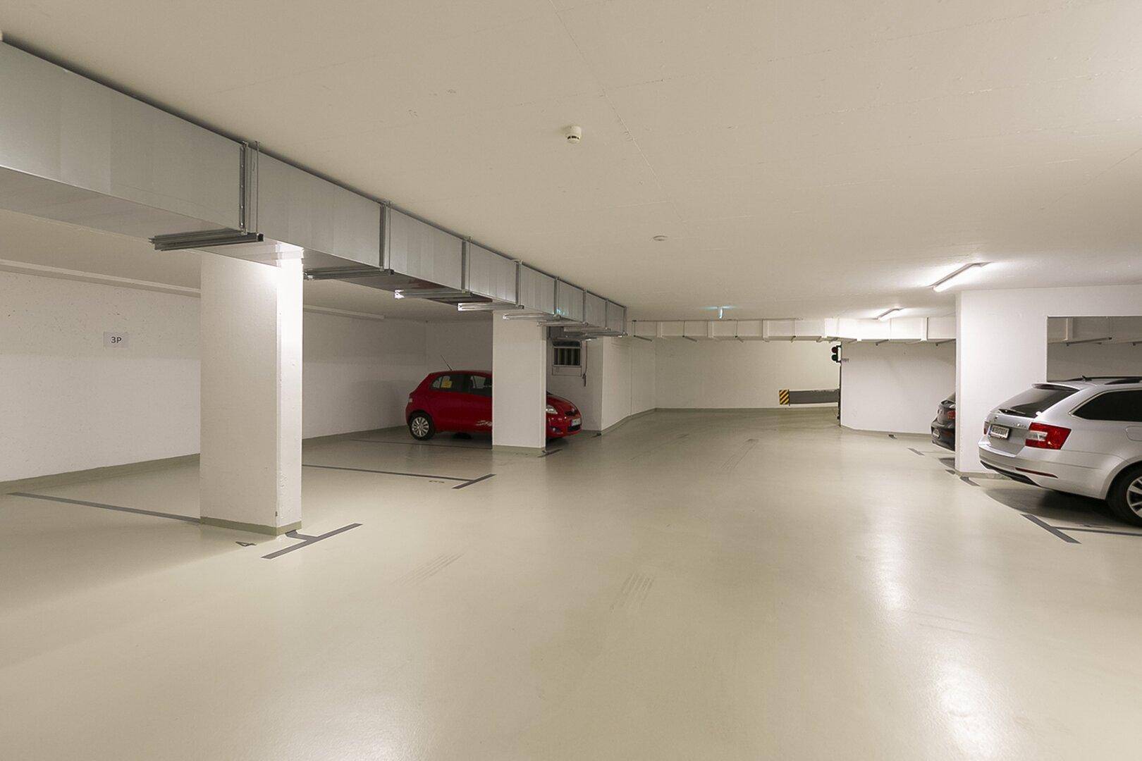 Geräumige Tiefgarage mit mehreren Stellplätzen und guter Beleuchtung.