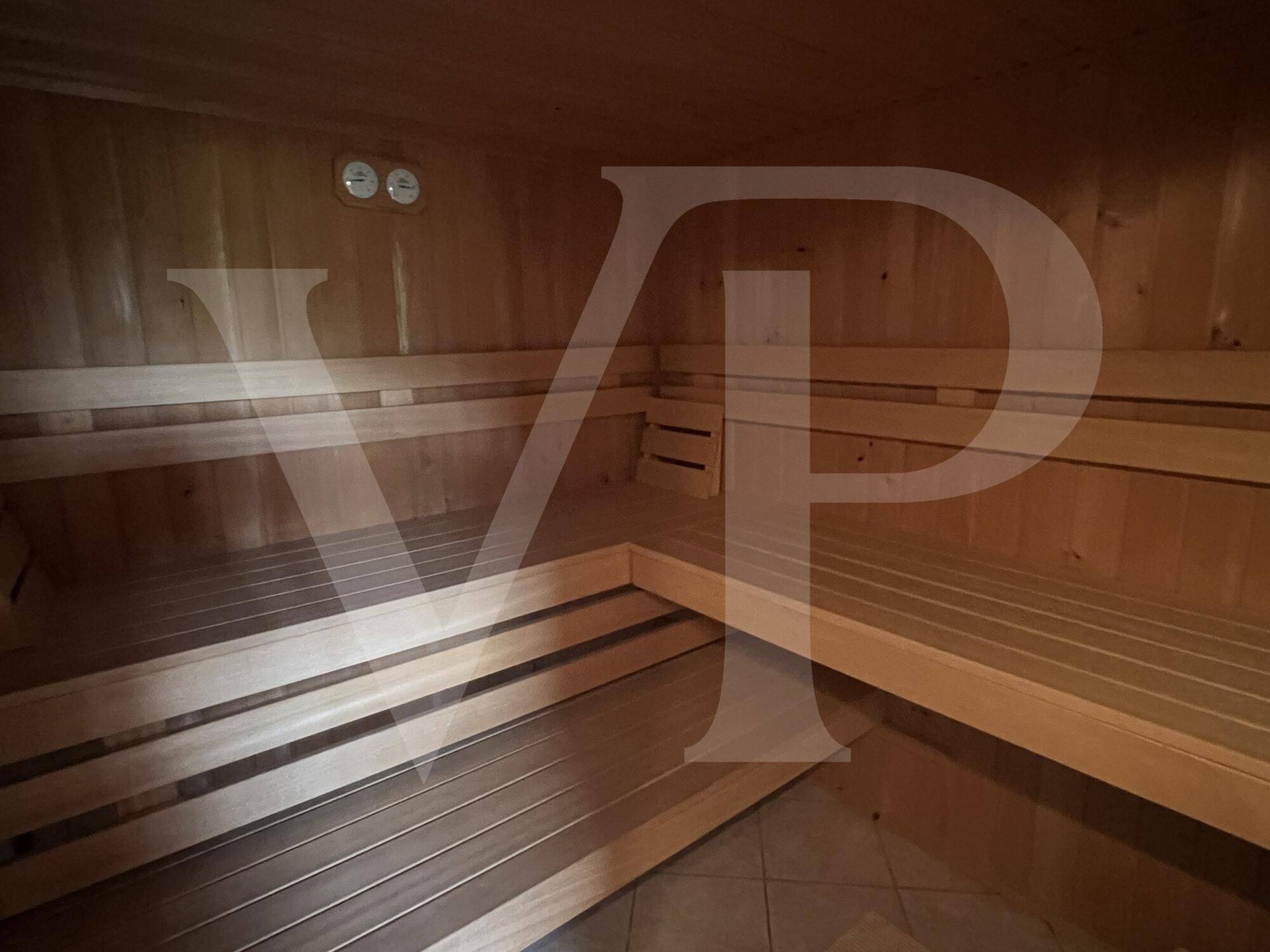 Holzvertäfelte Sauna mit mehreren Sitzebenen für Entspannung und Wellness.