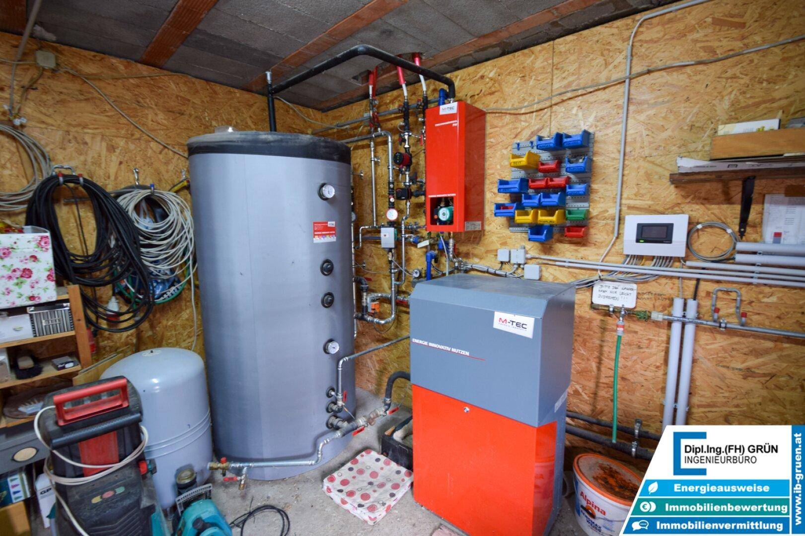 Technikraum mit großem Warmwasserspeicher und Heizungsanlage, gut organisiert und funktional.