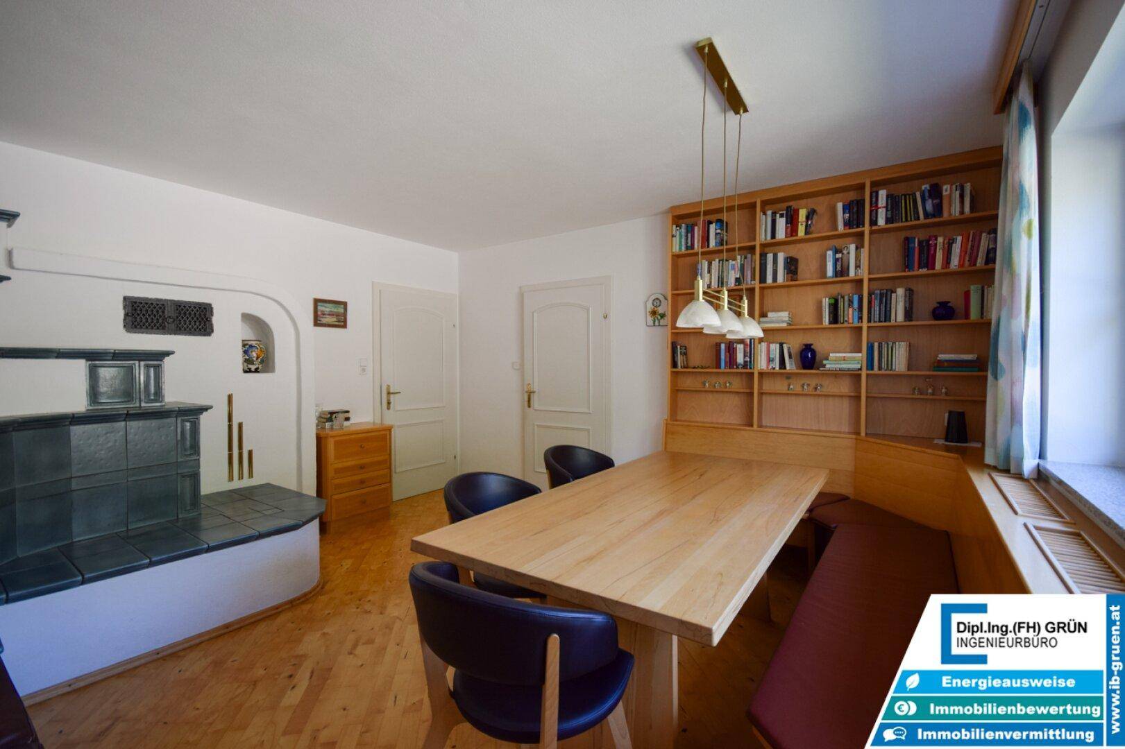 Geräumiger Essbereich mit Holztisch, Eckbank und großem Bücherregal.