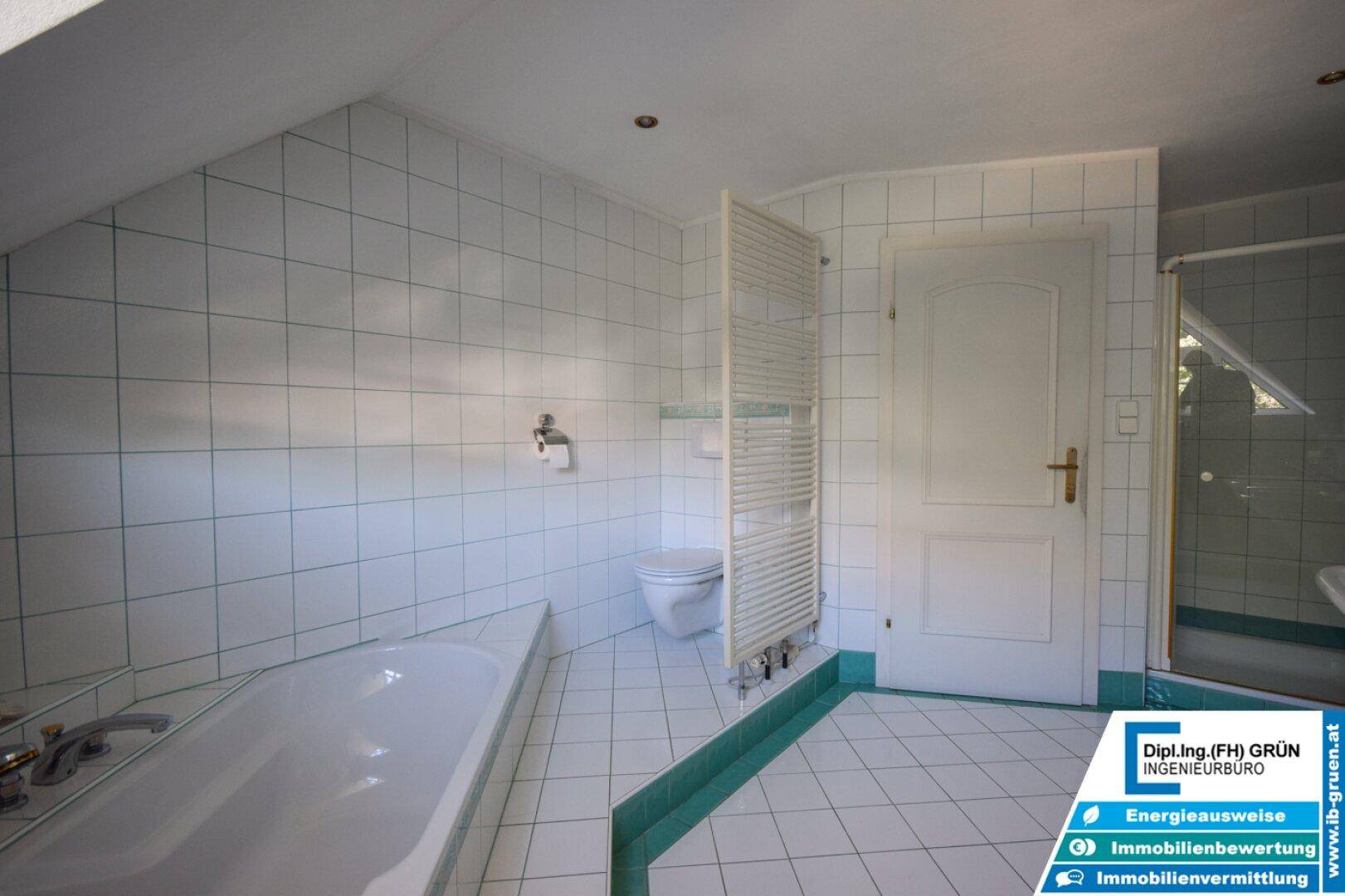 Badezimmer mit WC, beheiztem Handtuchhalter und Duschkabine.
