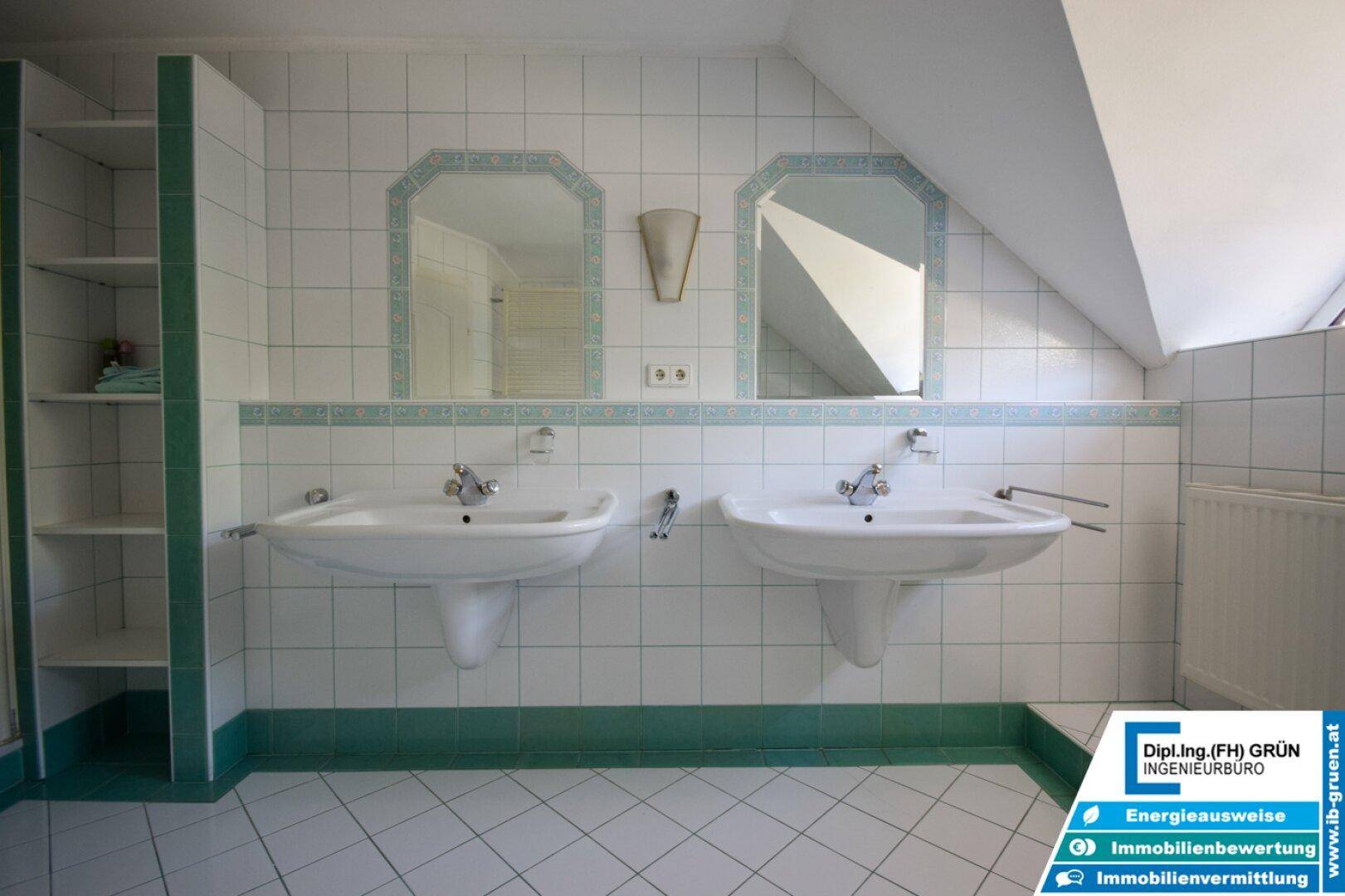 Badezimmer mit Doppelwaschbecken und großem Spiegel.
