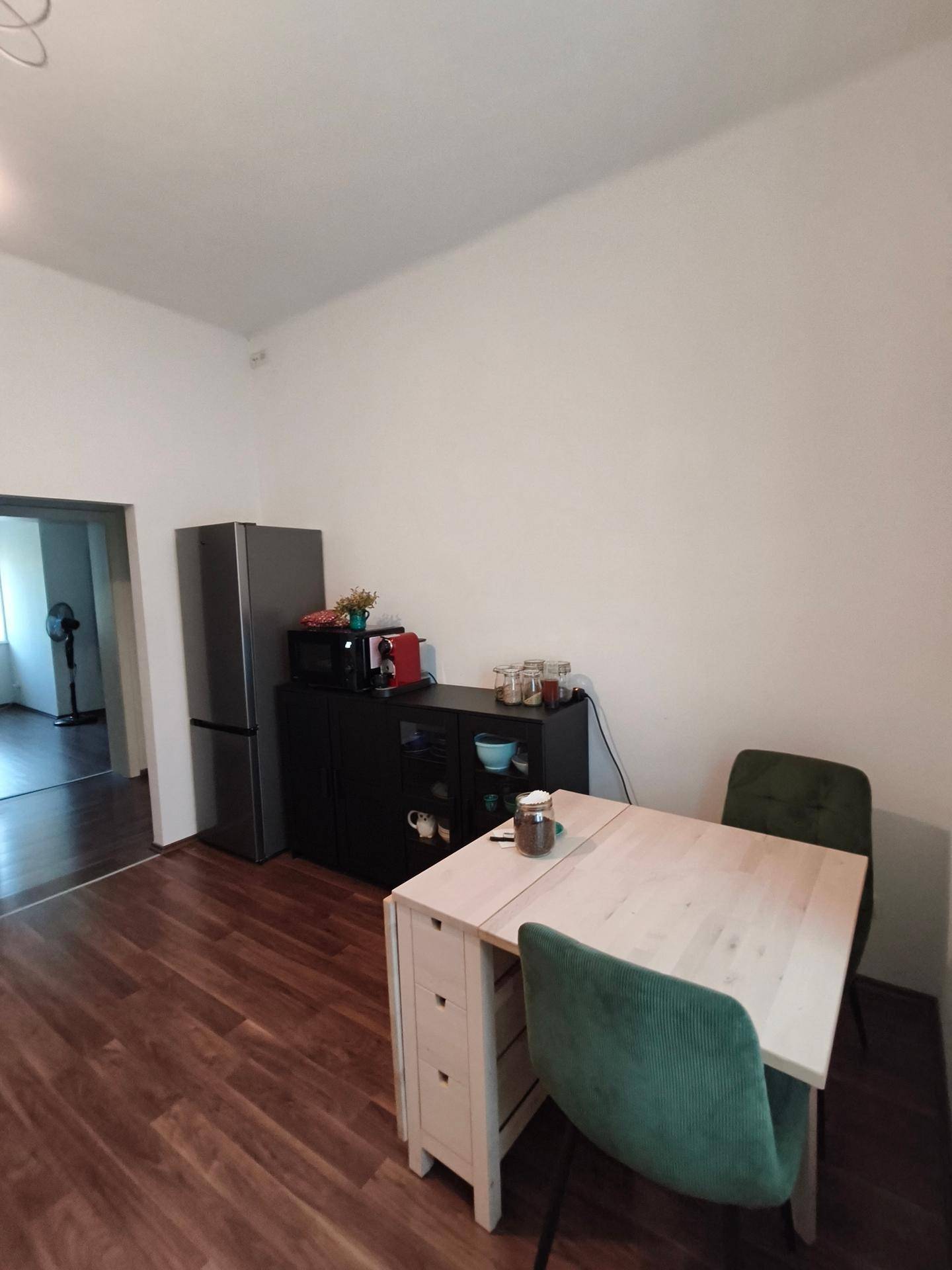 Essbereich mit ausziehbarem Tisch, Kühlschrank und Stauraum, angrenzend an die Küche.