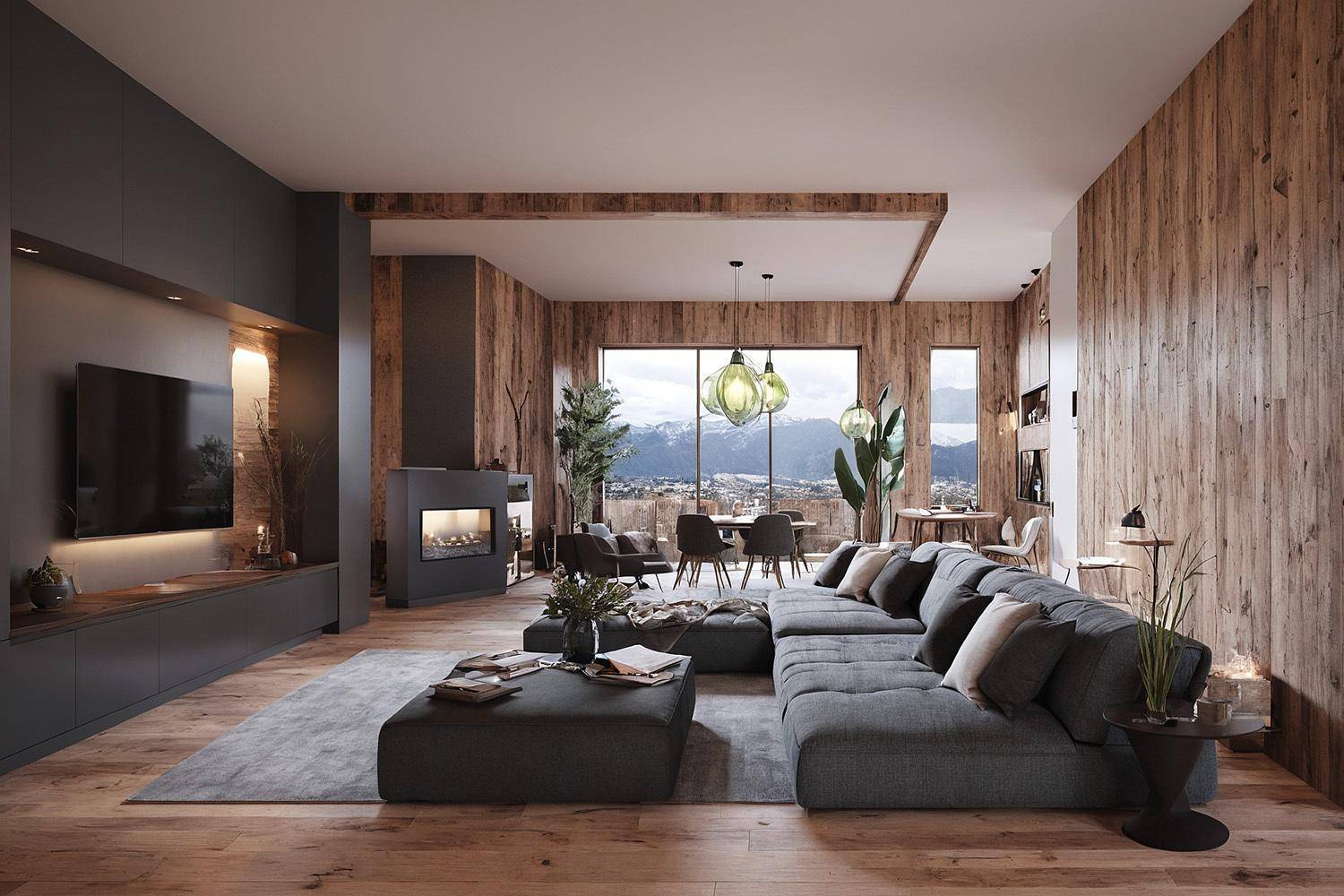 Geräumiges Wohnzimmer mit großem Sofa, Kamin und Panoramablick auf die umliegende Landschaft.