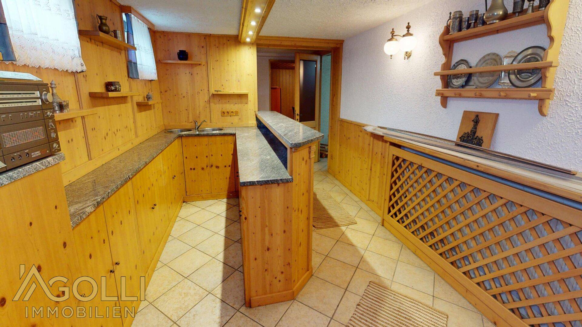 Rustikaler Barbereich im Untergeschoss mit Holzvertäfelung, Theke und traditioneller Einrichtung.