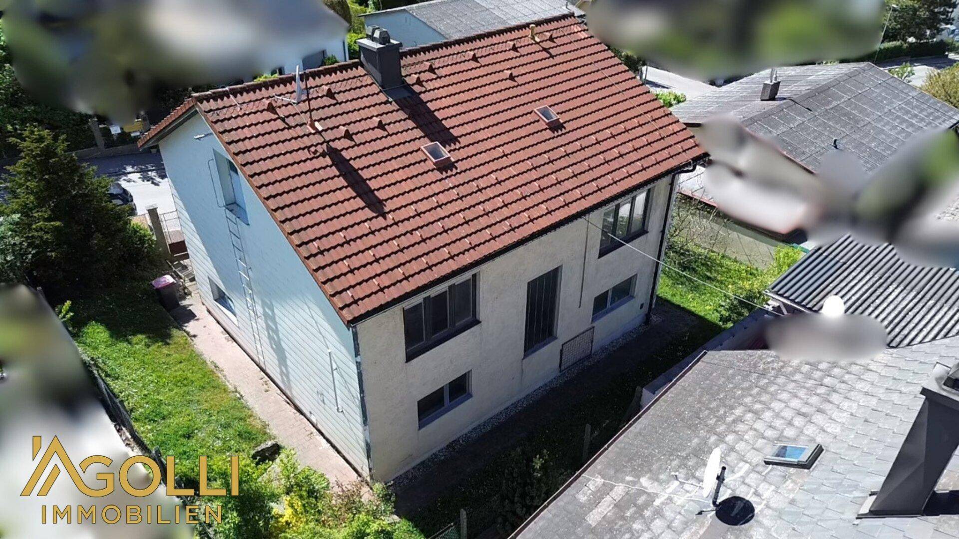 Luftaufnahme des Hauses mit Ziegeldach und umliegenden Grundstücken.