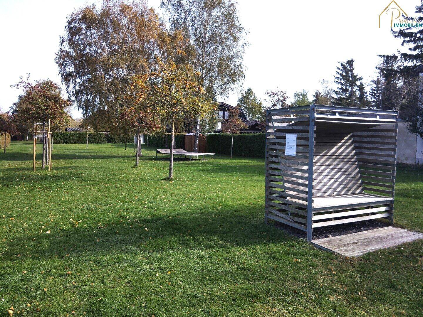 Flur mit Holzvertäfelung, Spiegel und Zugang zu weiteren Räumen und zur Terrasse.