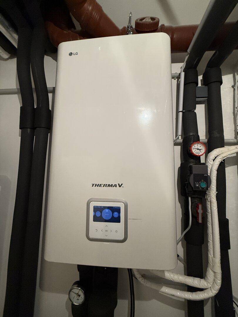 Detailansicht der modernen LG Therma V Wärmepumpe im Technikraum.