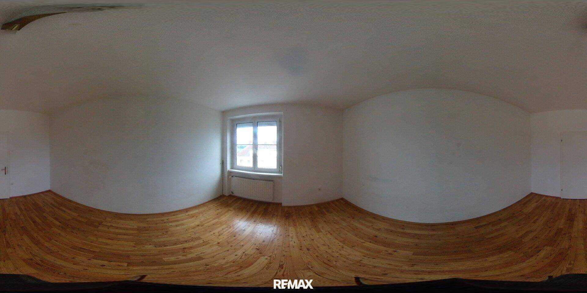 Rundumblick in ein weiteres leeres Schlafzimmer mit Holzboden und viel Tageslicht.