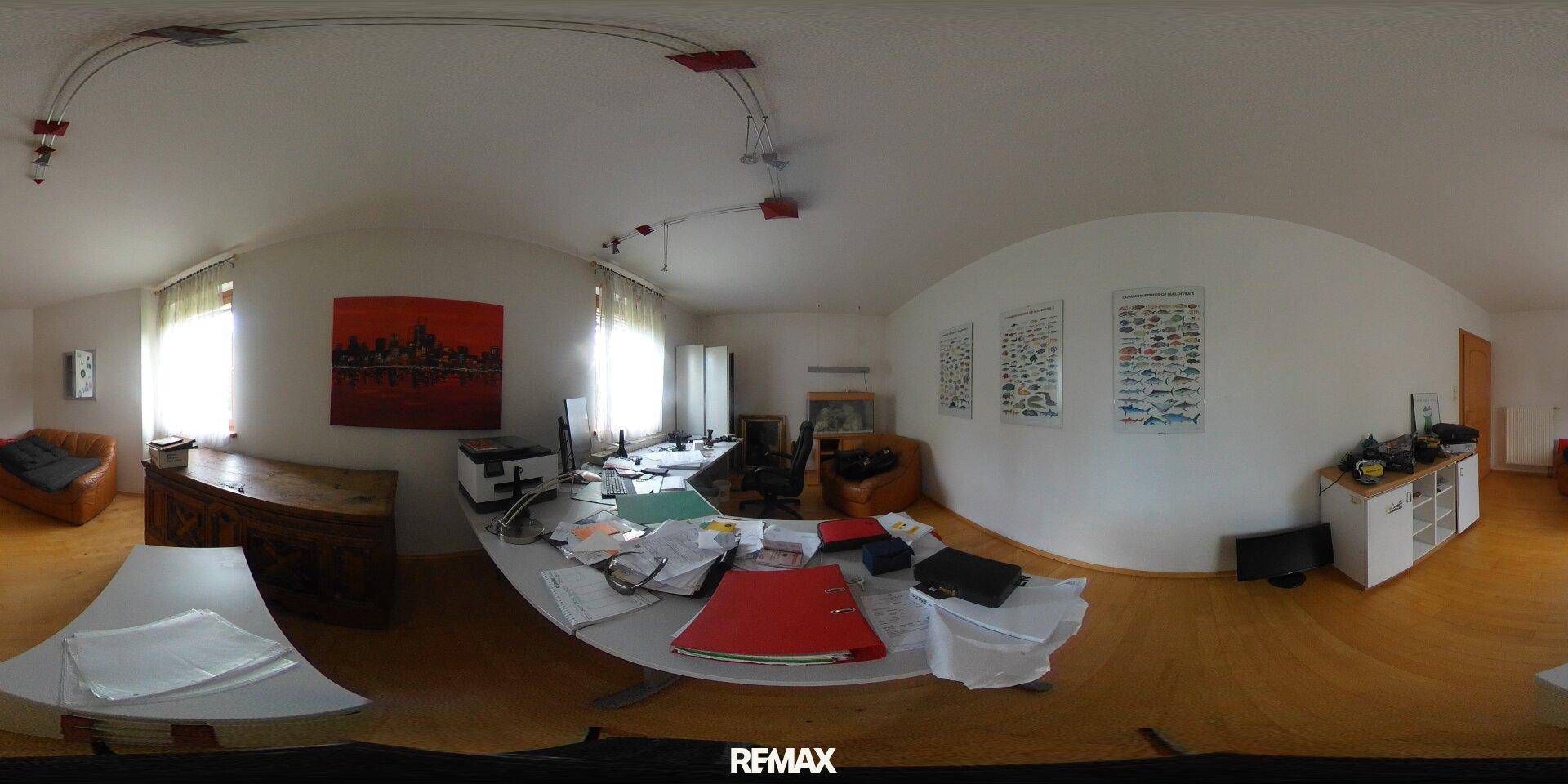 Helles Büro mit Holzboden, großem Schreibtisch und Fenstern für eine angenehme Arbeitsatmosphäre.