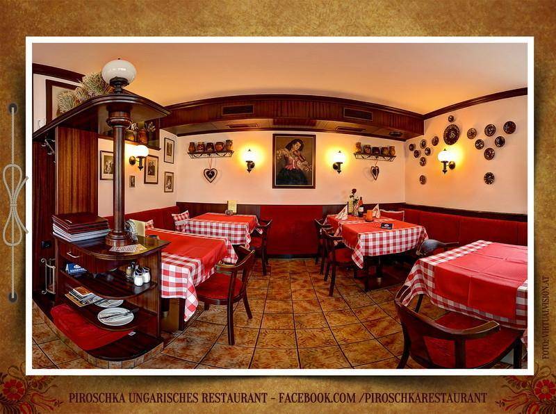 Gemütlicher Restaurantraum mit traditionellen Möbeln, roten Akzenten und dekorativen Wandleuchten.