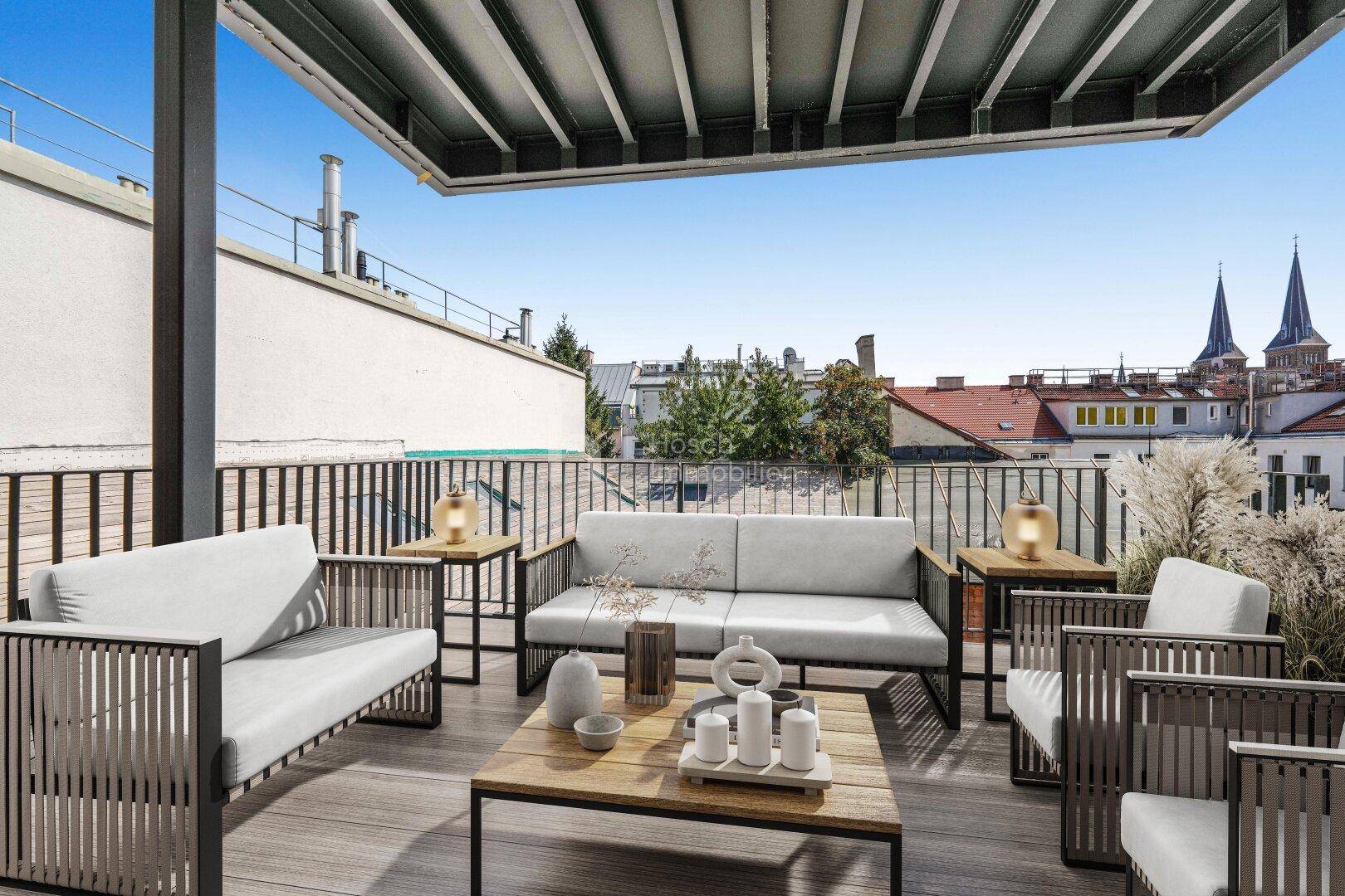 Möblierte Dachterrasse mit Lounge-Möbeln und weitem Blick über die Stadt.