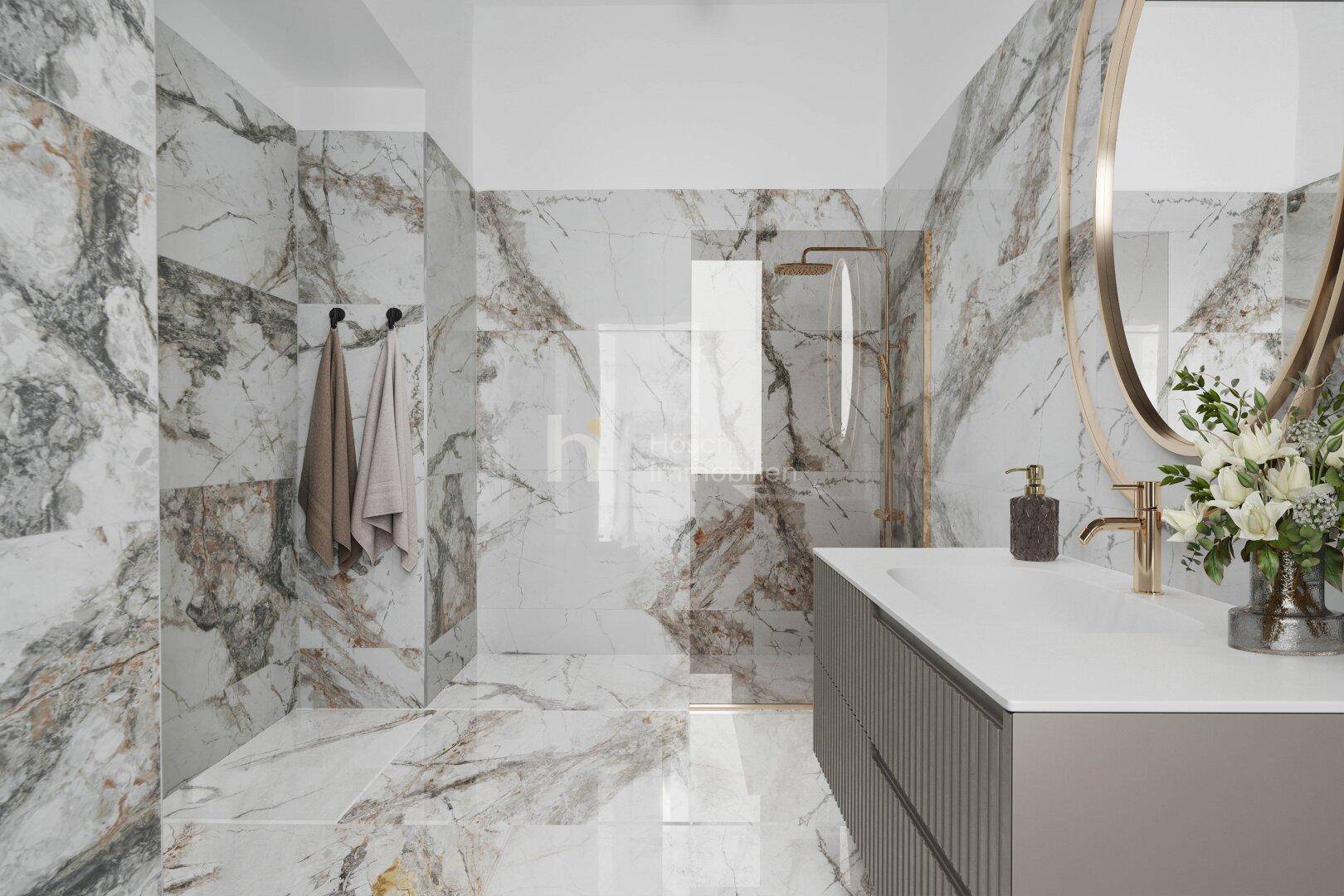 Luxuriöses Badezimmer mit großformatigen Marmorfliesen, modernem Waschtisch und begehbarer Dusche.